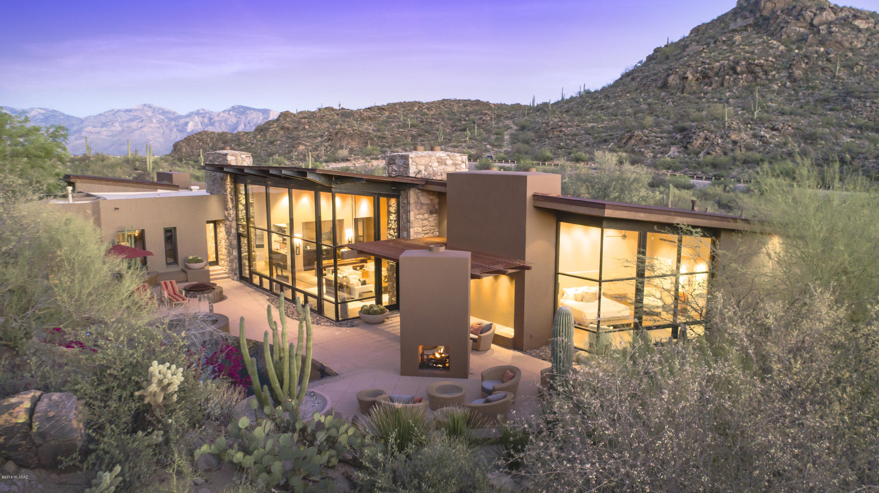 Private Retreat by award winning architect Michael Franks on 13 acres in prestigious Saguaro Ranch w/one-of-a-kind entry through mountain tunnel w/24-hour manned gate. Modern contemporary design w/exquisite earthy materials for perfect blend of comfort & desert living. Integrated into granite hillside, the vertical structure emerges as part of surrounding terrain & precisely relates to adjacent rock outcroppings as an extension of the architecture. Spectacular Mountain & Sunset views, stunning 4,721sf home has 2 master suites w/private patios + 670sf 1 bedroom suite guest casita. Magnificent wall of windows faces private saguaro-studded hillside. Several patios & outside living spaces enhance the pristine desert living experience w/Zen water feature, pool & spa. Incredible property!