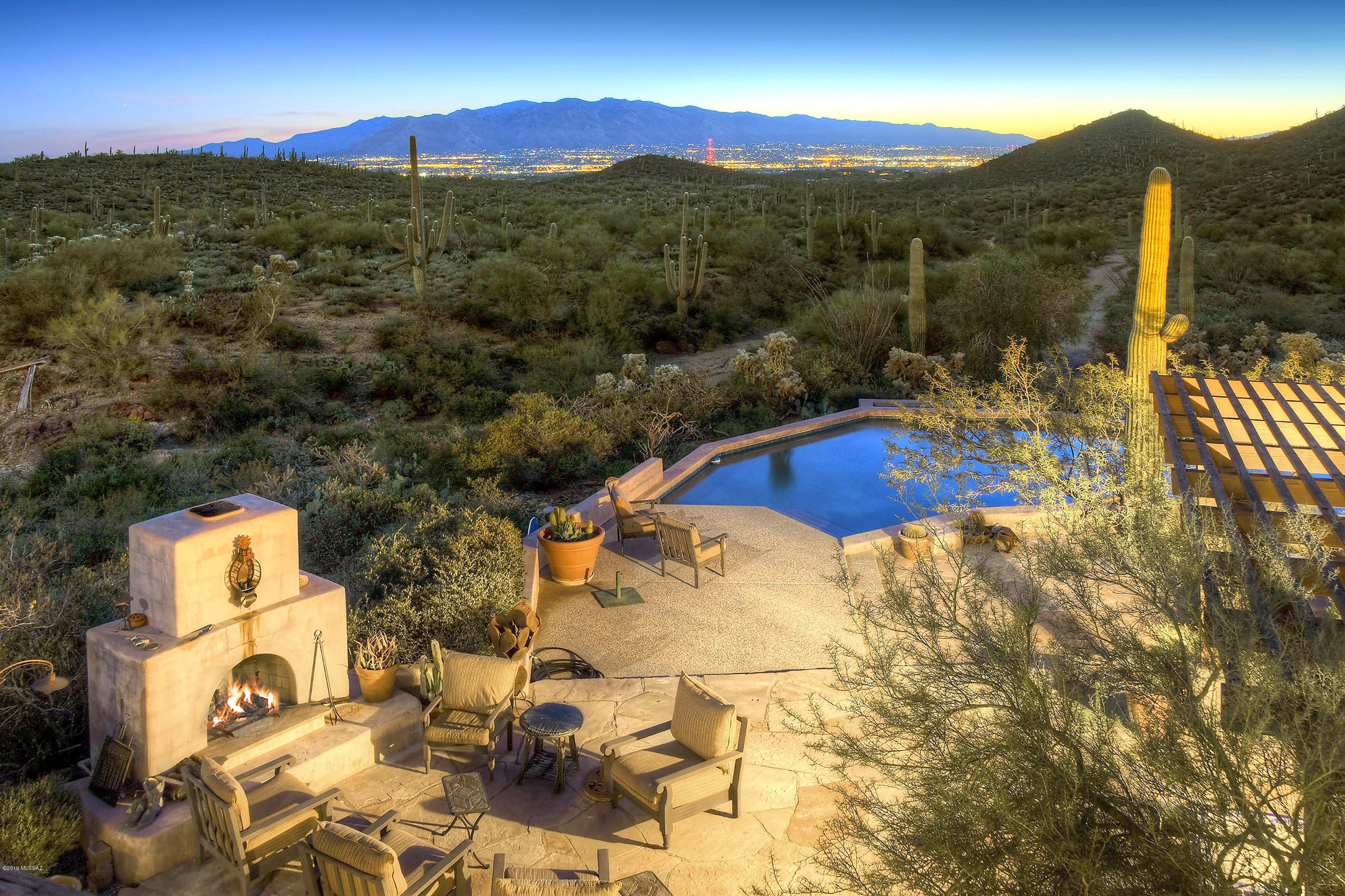 You found it! Tired of traffic, noise, crowds? You didn't come to Tucson to live in the city. You came for the beauty of its dramatic sunsets, stately saguaros and beautiful desert vistas. Privacy is what you want...need. And, add to that a beautiful city light view at night, yes? Welcome home! 40 acres of pristine land surrounded by Saguaro National Park is the setting for your beautiful 5 bedroom, 4400 square foot home. Plenty of room for family and friends. There is even a private master retreat with his and her bathrooms. A dream come true to escape from the everyday stresses of life. A unique property for a unique family.