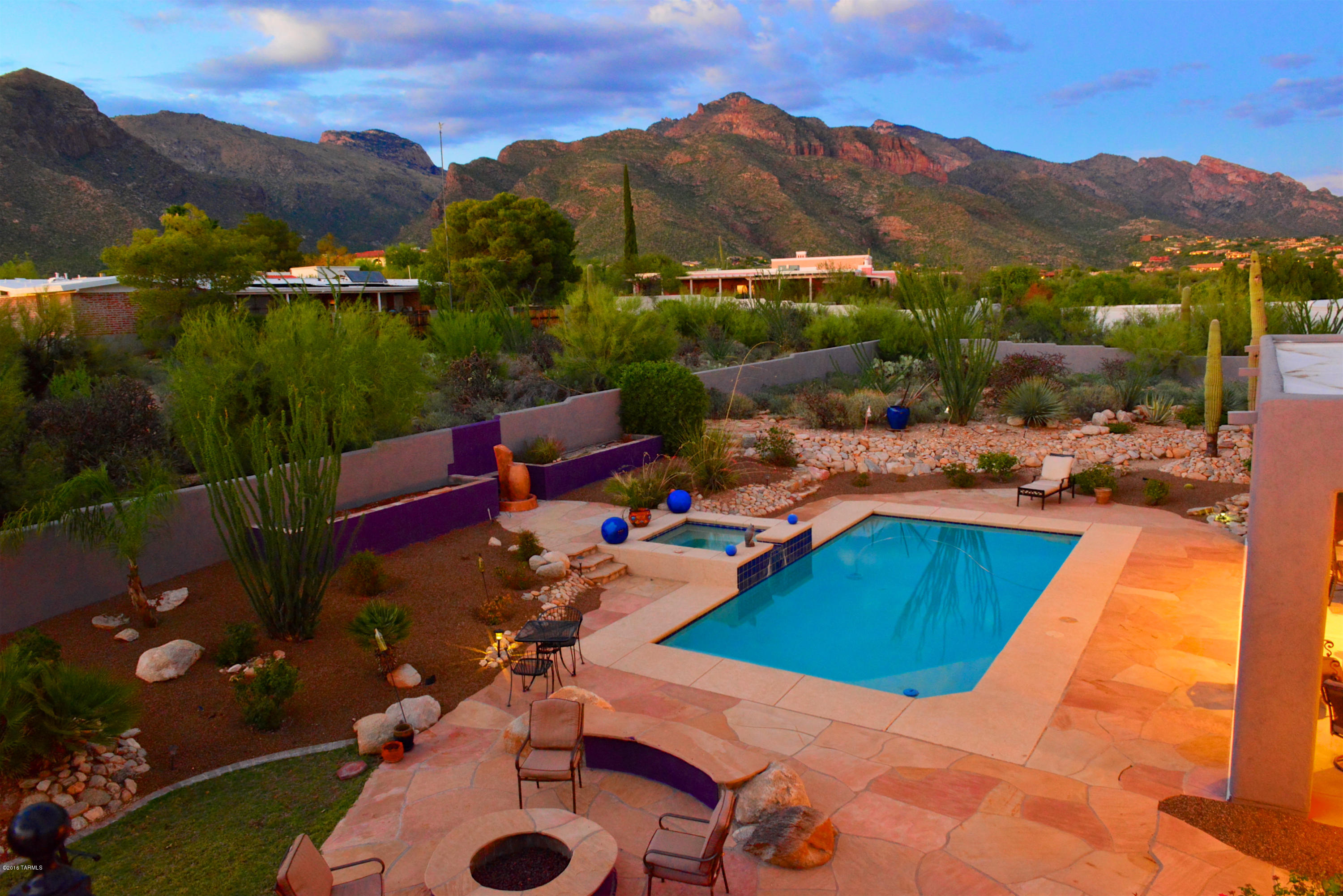 Nestled in the desirable Catalina Foothills, this privately gated home is situated on .86 acres and overlooks all of Tucson. This well crafted home boasts 3 Bed/3 Bath plus a Den and has a unique Dual Master Suite with Jack and Jill Master Bath. Grand entry leads to the formal living and dining rooms with beamed ceilings and a wall of windows to take in the spectacular up close mountain views. Natural light floods this open floor plan and creates an atmosphere of spacious comfort throughout the home. Gourmet kitchen flows into a generous family room with cozy two-way fireplace. Enjoy exceptional outdoor living in the expansive backyard with lush vegetation, sparkling pool & spa w/ waterfall, fire pit, and roof top terrace with stunning 360 degree views of all mountain ranges and the city!