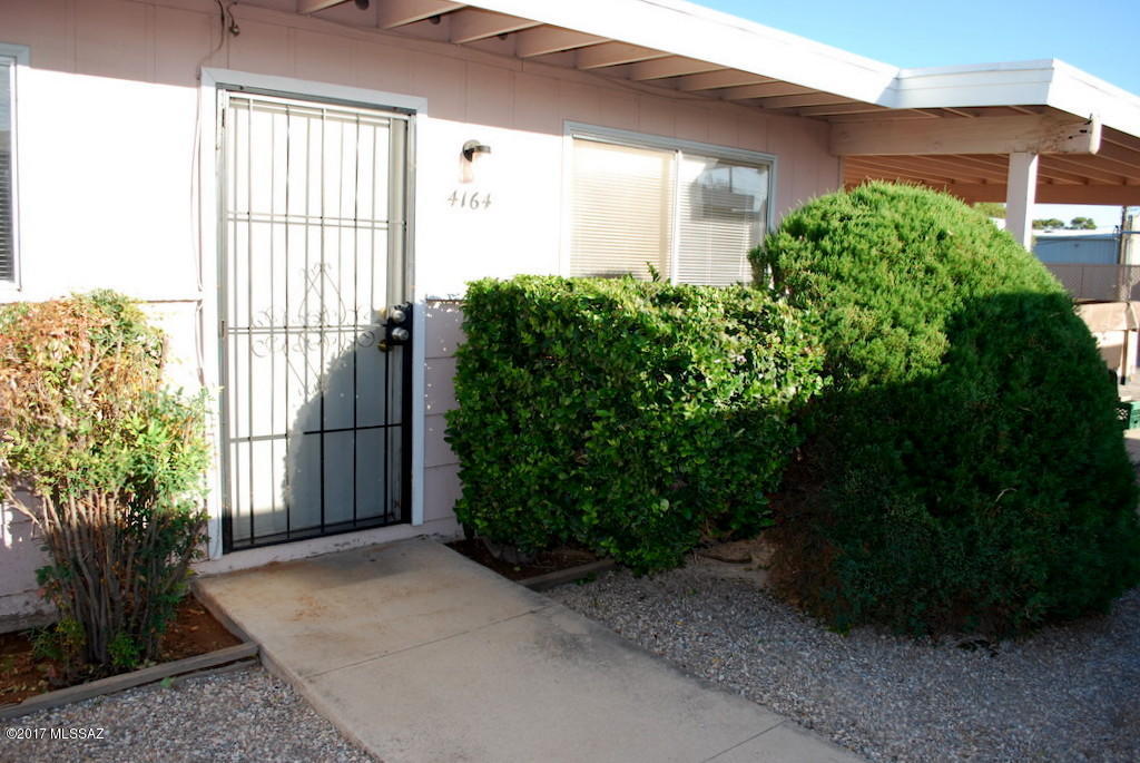 Central Tucson 2 Bedroom 1 Bath. Quiet and private complex with lots of mature landscaping and covered parking. 950 square feet. Eat-in kitchen with tile floors. Tile floors in all wet areas and carpet in living room and bedrooms. Indoor and outdoor storage, washer/dryer hookups and fenced in yard. Water is included in rent. Evap Cooling. Only service or assistance living animals with documentation allowed.