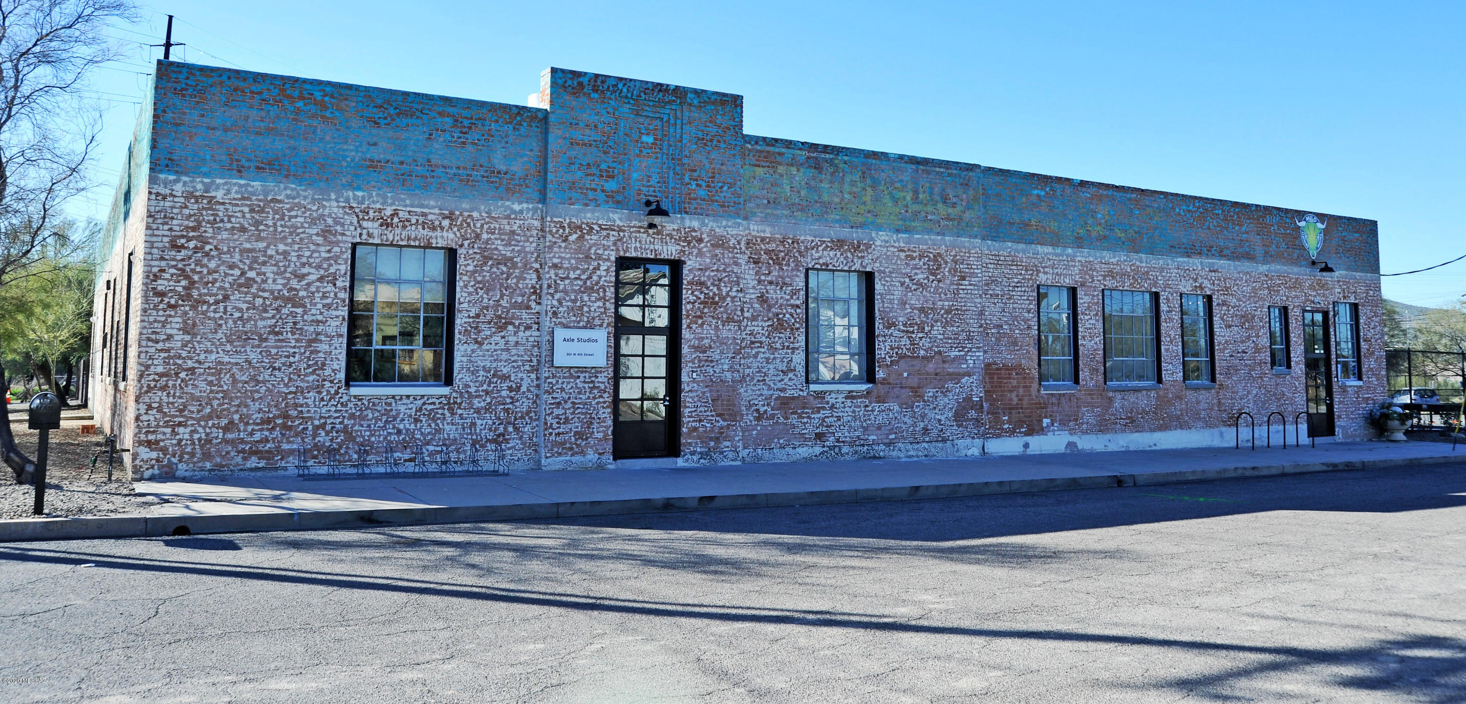 Repurposed warehouse located just north of downtown. Built in 1925 the double and triple brick structure has striking architectural features including a bow truss roof system and restored steel casement warehouse windows. 5,000 square feet of the buildings former offices were converted into 12 separate creative spaces which are leased individually to established long term artist tenants and other creative office space users. The adjacent 5,000 square feet is occupied by a successful local CrossFit gym who has a long-term lease. Building upgrades in 2015 include: new insulated roof system, electrical improvements and HVAC. Clean Phase I & II reports available. Solid NOI, zero vacancy with waiting list, stable long-term tenants and initial plans for another building on the site.
