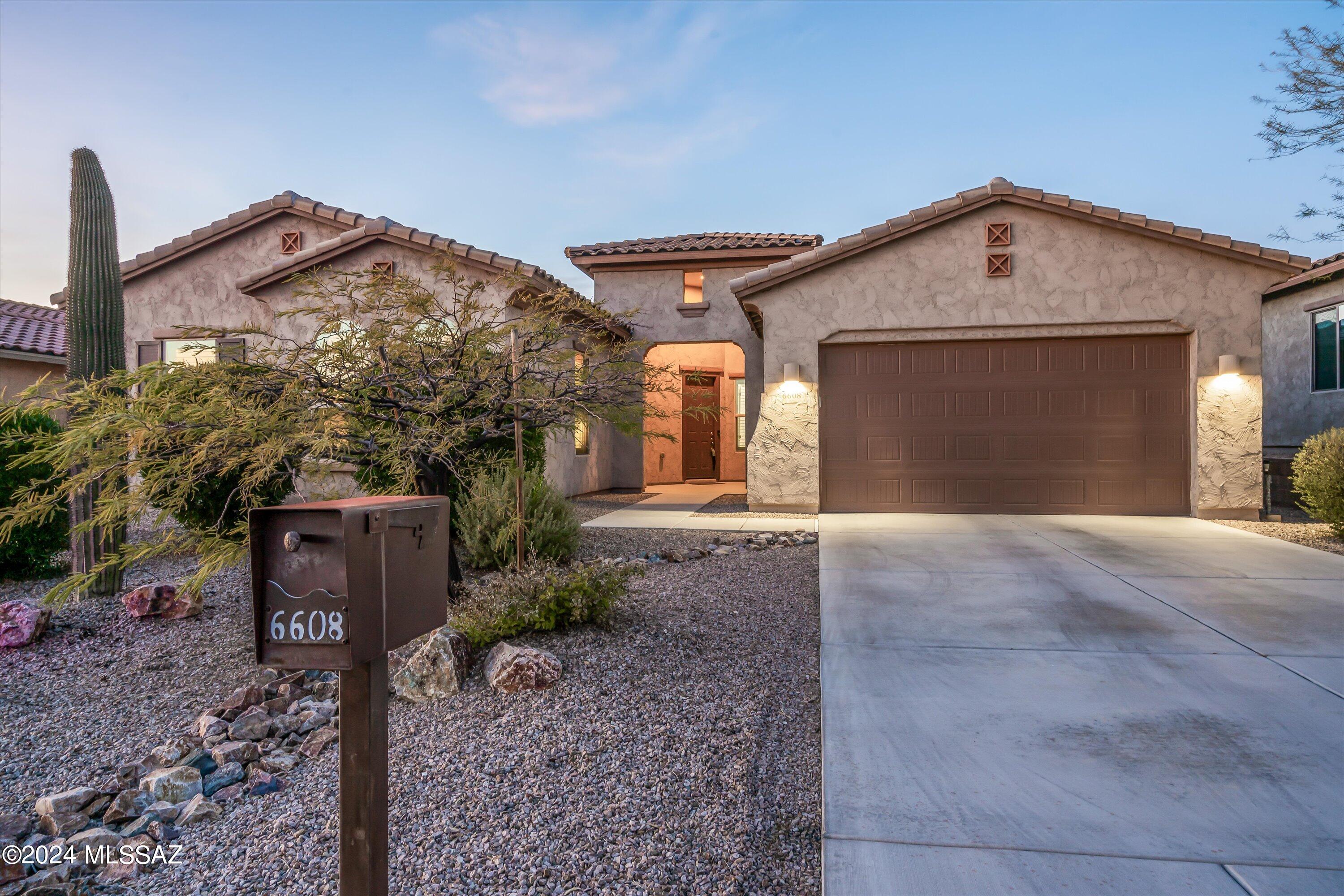 Welcome to the gated and prestigious Los Saguaros neighborhood perfectly nestled in quiet neighborhood streets with mountain and sunset views for days! Walk in to warmth, soaring ceilings, open concept living and a perfect blend of style and functional comfort! The chefs kitchen is adorned in quartz counters, center island, new LG fridge, double ovens, cabinets galore, and room to entertain family and friends! The kitchen opens to the great room and overlooks the deep covered patio and mountains beyond. The primary bedroom is a true retreat with spa like bathroom including oversized shower, dual vanity, and walk in closets. The split floorplan creates perfection in privacy and space for all. The guest wing includes bedroom suites and flex space for study or games. Out back, the deep paver patio and sparkling pool and spa create a resort like feel that must be seen to be appreciated! The views to the north and to the west are truly special. Enjoy the Dove Mountain lifestyle with miles of hiking and biking trails, world class golf courses, Club at Dove Mountain/Gallery Golf & Fitness club, restaurants, 5-star Ritz Carlton Resort near-by. Don't miss the office nook, tandem 3 garage, and attention to detail throughout. Incredible pride of ownership blended with style, elegance, convenience, and comfort, this home is special in every way!