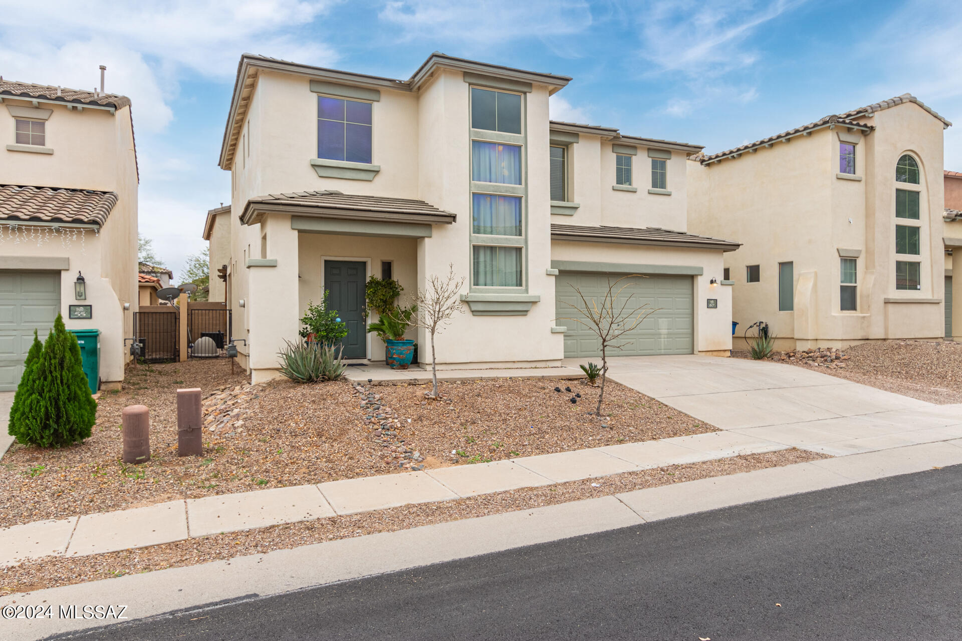 The search is finally over! This beautiful two-level residence in Rancho Sahuarita is NOW on the market. Prepare to be impressed by a harmonious living area offering glossy wood-look floor, high ceilings, & neutral palette throughout. The immaculate eat-in kitchen showcases stainless steel appliances, track lighting, & white cabinetry, providing plenty of storage for your cooking essentials. The primary bedroom boasts a private bathroom equipped with dual vanities for added comfort. Discover the charming backyard featuring a pergola-style covered patio perfect for alfresco dining or simply relaxing with a glass of wine! Don't let this opportunity pass you by!