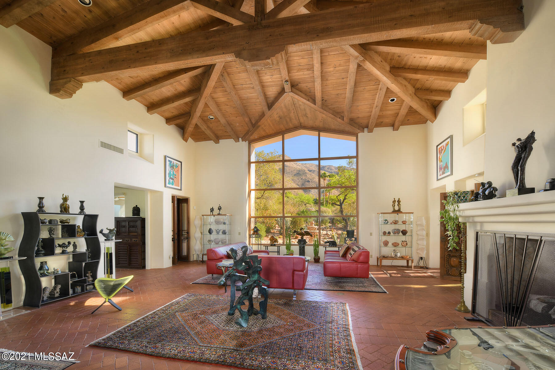 Sellers will accept or counter offers $1,425,000-$1,495,000 for this STUNNING, one-of-a-kind ''Art as Home'' Spanish style masterpiece in prestigious, gated Skyline Country Club w/ reach out & touch the Catalina Mountain views. Gated entry w/ paver driveway leads to courtyard & into great room w/ herring-bone brick floors, soaring GORGEOUS beamed cathedral ceiling, floor to ceiling window framing the mountains, majestic fireplace, carved pillars & circular staircase leading to loft/study w/ walk-out balcony. Lovely remodeled kitchen. Family room w/ fireplace could be 3rd bedroom w/ adjacent full bath & outdoor screened-in family room w/ beamed ceiling. Cantera fireplace, carved doors, unique wrought iron, paved walkways. Words & photos can't describe the BEAUTY of this ONE-OF-A-KIND HOME! Many special architectural features: arches, columns, niches, built-ins, hardware and fountains!  Owned solar (electricity bill in 2020 was $400 total). New garage doors. Upgraded closets. Many rolling shutters/shade screens. Mature landscaping/gardens, intimate covered patios and incredible privacy! All on one level with the exception of the circular staircase up to loft. This home has been meticulously cared for! Truly a "WOW" house...