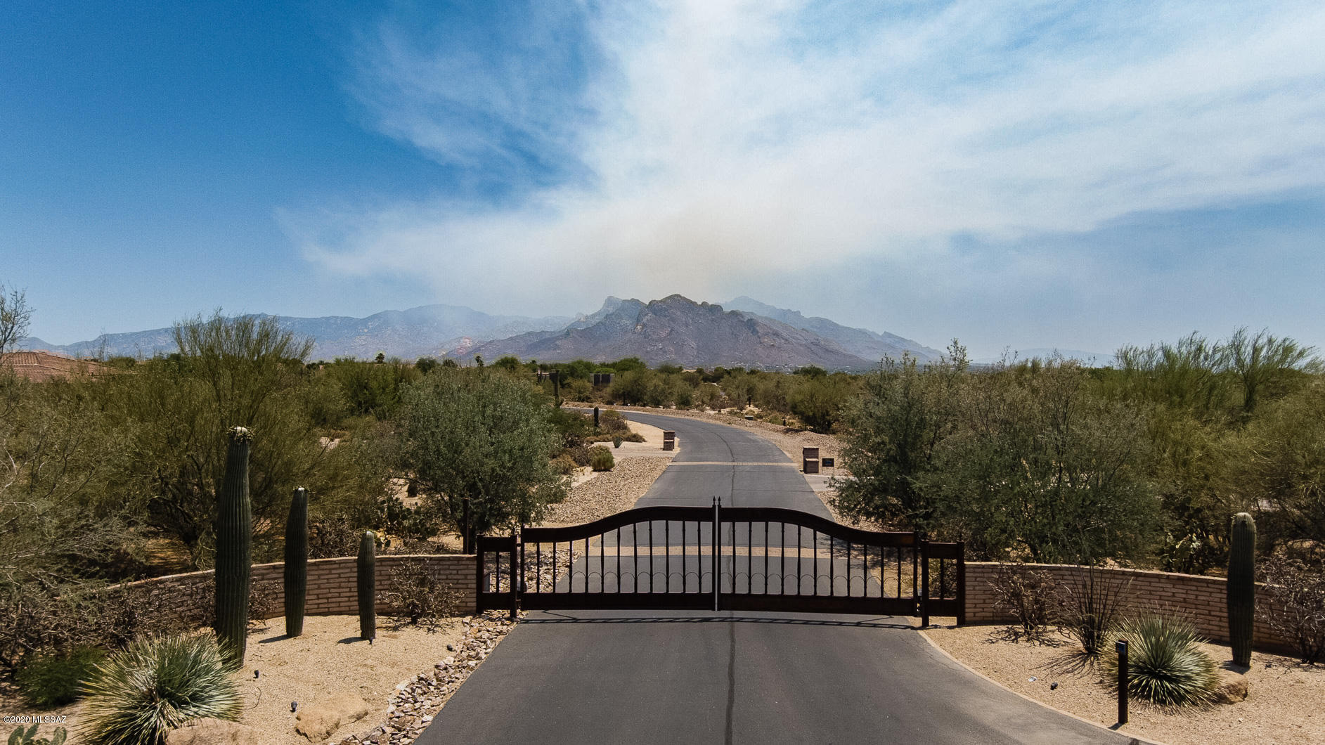 Golf Enthusiast...Private secluded lot in this Gated Community of Custom Built Homes with Golf Cart access to Omni Hotels & Resorts Tucson National (Must join Club Membership for access through locked gate at corner of property) Hosted over 30 PGA Tour Events, legendary golf history since the early 1960's, resort, restaurants, spa, etc.  Your Custom Built Dream Home has Mountain Views of Catalinas and Golf course. Abundant, lush mature vegetation. Underground utilities/paved streets, Flat building areas. Very private but close to shopping, restaurants. Guest house allowed.