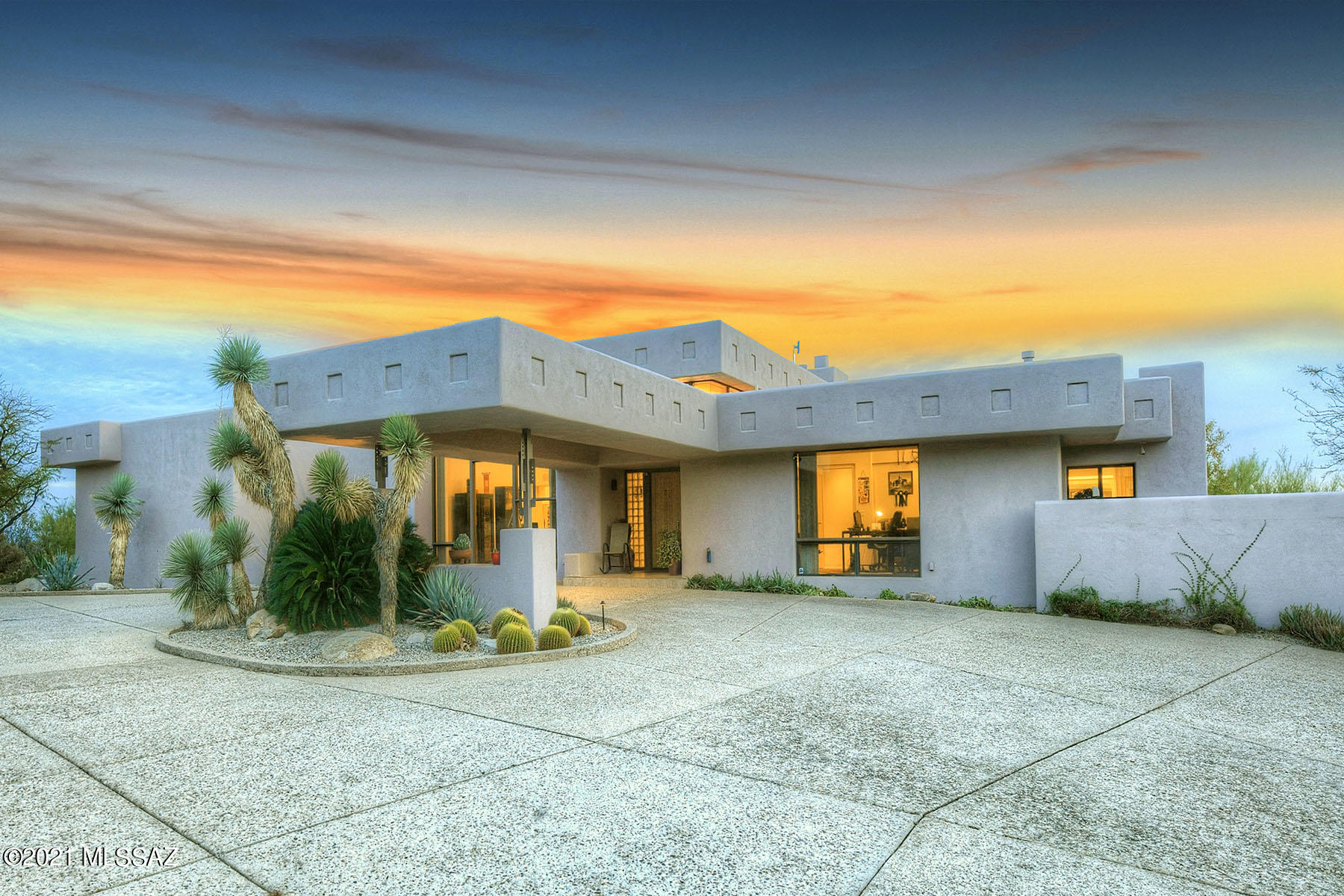 High on a hill in prestigious, guard-gated La Paloma Estates, this remarkable 4,737 sq. ft. Tyson-Murphy contemporary offers top-of-a-cul-de-sac location with sweeping Catalina Mountain & city views! Highlights include a long & winding driveway, a dramatic porte-cochère entry, a grand foyer, soaring wood-planked ceilings in the main living areas, three fireplaces, neutral ceramic tile flooring, and walls of windows framing scenic views. The fabulous gourmet island kitchen, open to the family room, provides granite countertops, stainless steel appliances, and an oversized walk-in pantry. The gracious master suite features a wall of glass, a cozy fireplace, a walk-in closet, dual vanities, a spa tub and a steam shower. The attached guest quarters offer a living room with a kitchenette & breakfast bar, a bedroom with walk-in closet and a bathroom. The generous 3-car garage includes a storage room. Enjoy the beautiful back patio featuring an expansive covered porch, a built-in bbq, a spacious walled-in yard with play areas, a sparkling pool/spa, and sweeping vistas. District 16 Schools.