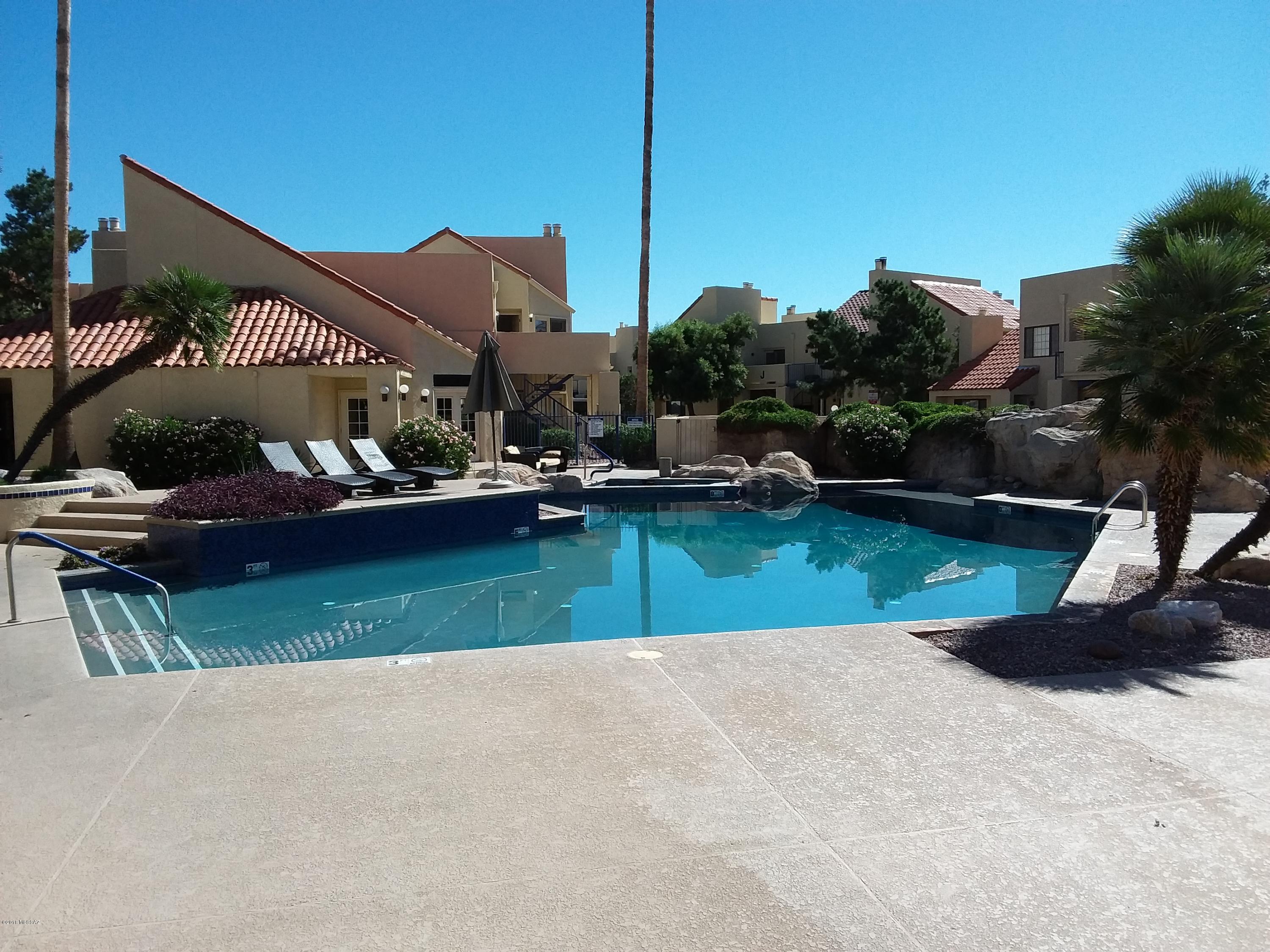 Immaculate upstairs unit with vaulted ceilings. Fully furnished. Features blue tile fire place in great room, refrigerator, washer and dryer in unit and microwave. Enjoy the community pool , spa, exercise room and club house. Also within walking distance to the Rillito River walk/bike path.