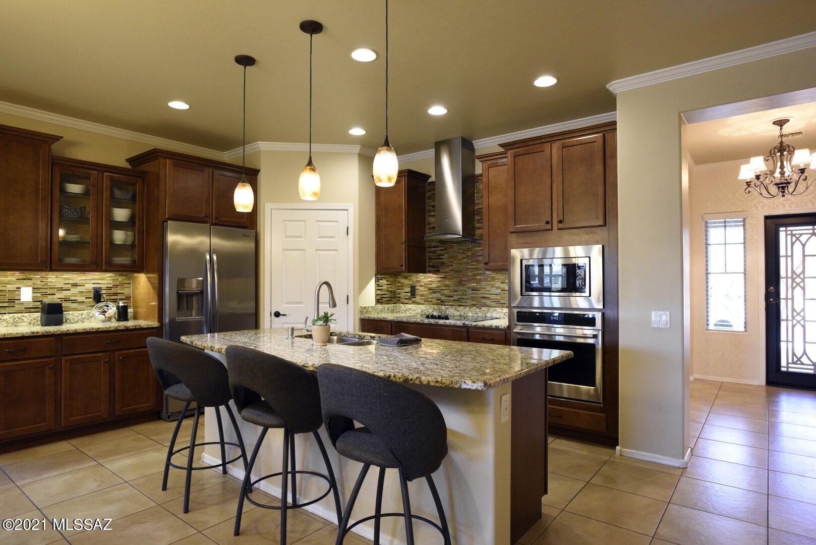 STUNNING SIERRA MORADO HOME is a must see! Located in the AWARD WINNING VAIL SCHOOL DISTRICT. 
This breathtaking GEM features 4 bedroom 2 bath with a 2 car garage. SPACIOUS, immaculate, one owner home with open floor concept, high ceilings and extensive upgrades make this home SHINE! Gourmet kitchen features custom metallic backsplash with beautiful granite countertops, spacious island for cooking and entertaining , SS appliances, rich dark cabinets with fused bubble glass doors- custom lighting throughout, Built- in entertainment center, built- in desk, wood floors in (office-den-front room) off entry. 12X12 tile through-out with Berber carpet in master. The back yard is the perfect place to entertain with outdoor kitchen- BBQ area and built-in fire pit. Imagine enjoying the Arizona Sunsets with a glass of wine on this beautiful patio with no neighbors behind you. Solar Panels. Neighborhood parks, dog park, pool, clubhouse, soccer field, and tennis courts nearby.