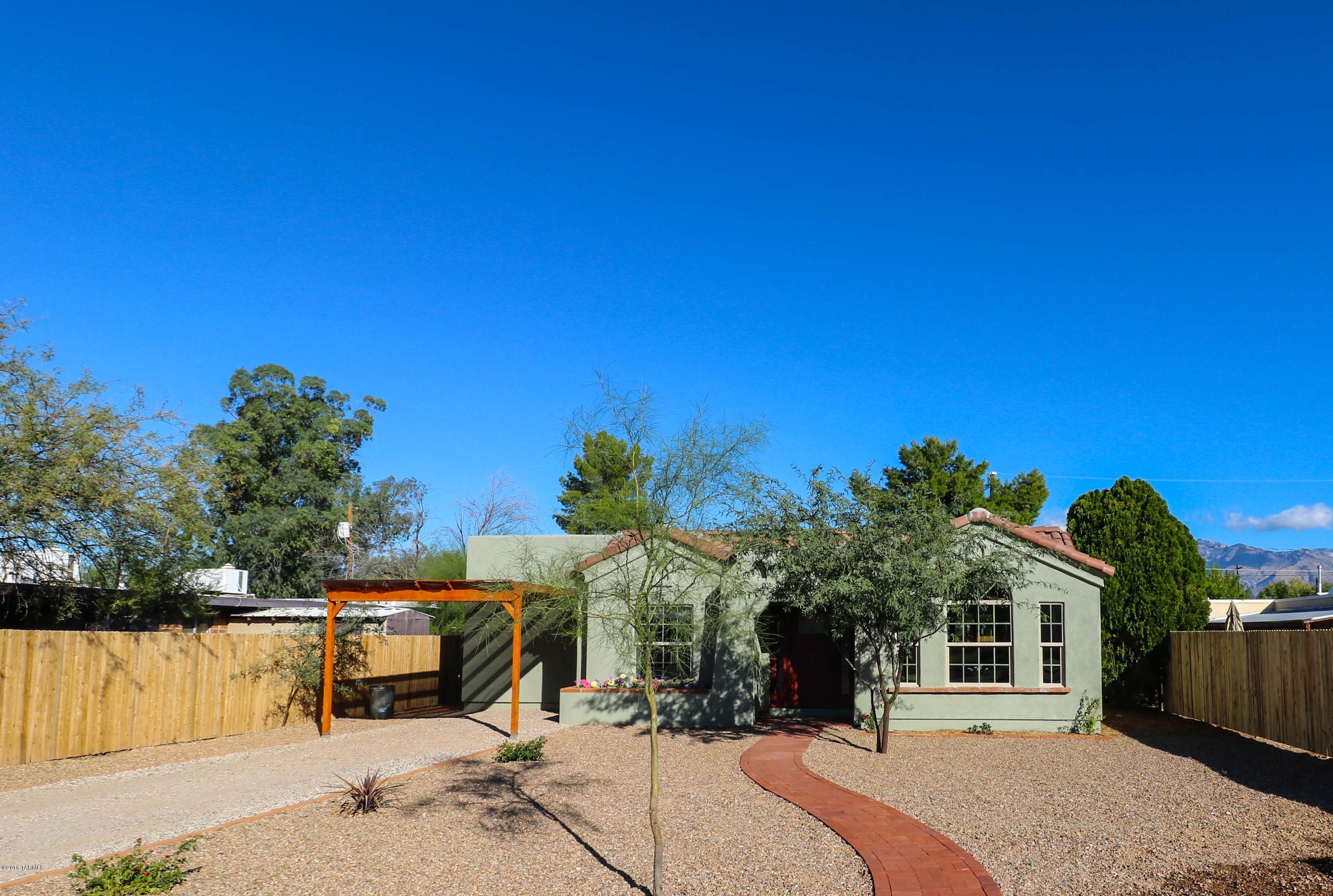 Just completed! Move in Ready! BRAND NEW construction in central Tucson! Open floor plan with vaulted wood beam ceilings, arched windows and mountain views! Modern kitchen with Whirlpool stainless steel appliances, french door refrigerator, granite counter tops and custom cabinets with soft close doors and drawers. Large master suite offers walk-in closet, custom his and her vanities in master bath, plus separate shower and giant soaker tub! Upgraded solid alder wood doors and ceiling fans throughout. Home built ''green'' with 2x6 framing, insulation, Low E windows and Trane air conditioning system. Professionally landscaped private backyard with lots of green grass on automatically timed irrigation system and brick patio for grilling. Great mid-town location and price!