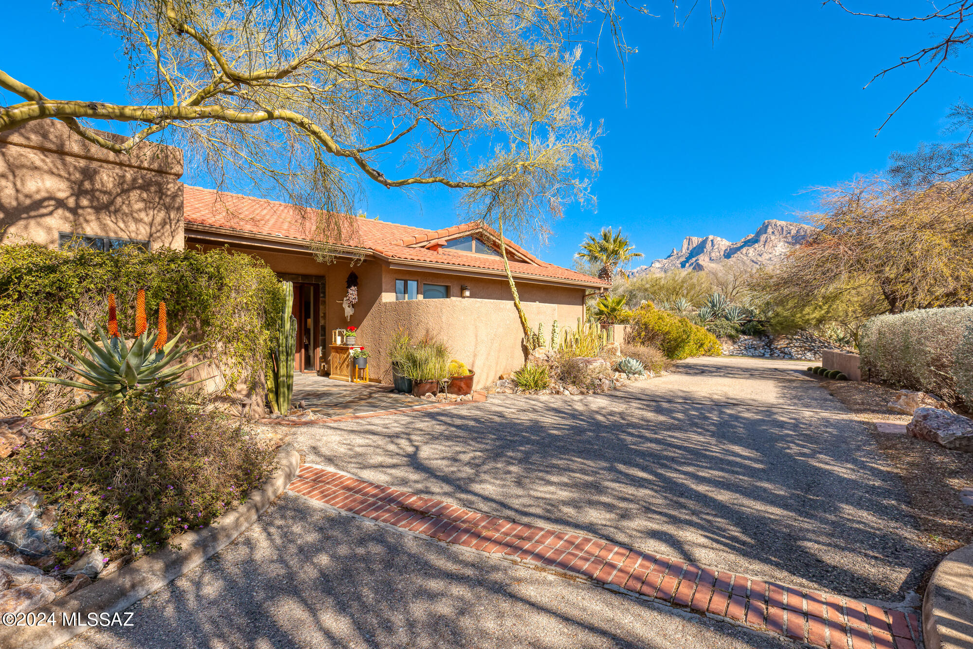 Spectacular 2BD/3BA +Den (2,648 sq ft) home on just over an acre boasts a renovated interior, sweeping mountain/golf course/city light views, sparkling pool and NO HOA! New roof. Elevated lot with circular drive flows to slate tile entry and large gathering room highlighted by sleek Travertine floors, cathedral wood-beam ceiling, picture windows and gas FP w/ tile surround. Formal dining area adjoins gourmet kitchen hosting island w/ gas cooktop, quartz counters and SS appls including wine fridge. Dual en suite bedrooms plus Den that can serve as 3rd bedroom. Entertain on the extended rear patio w/ built-in fire pit & BBQ island. Flagstone path leads to private patio w/ hot tub. Soak up the sun poolside while enjoying dual cascading fountains, lush vegetation and forever views.