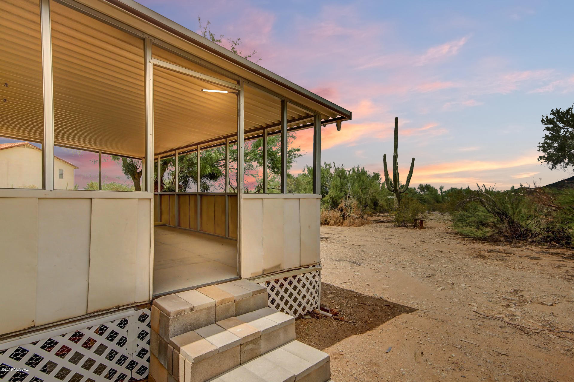 Great investment opportunity - This 3 bed 2 bath manufactured home, situated amongst an expanse of saguaros, has new paint, carpet and wood accent walls. Cozy up next to the wood burning stove or watch the monsoons roll in from the newly finished patio. Kitchen has all new cabinetry, white appliances, double sink, and walk-in pantry. Master includes full bath and double sinks.