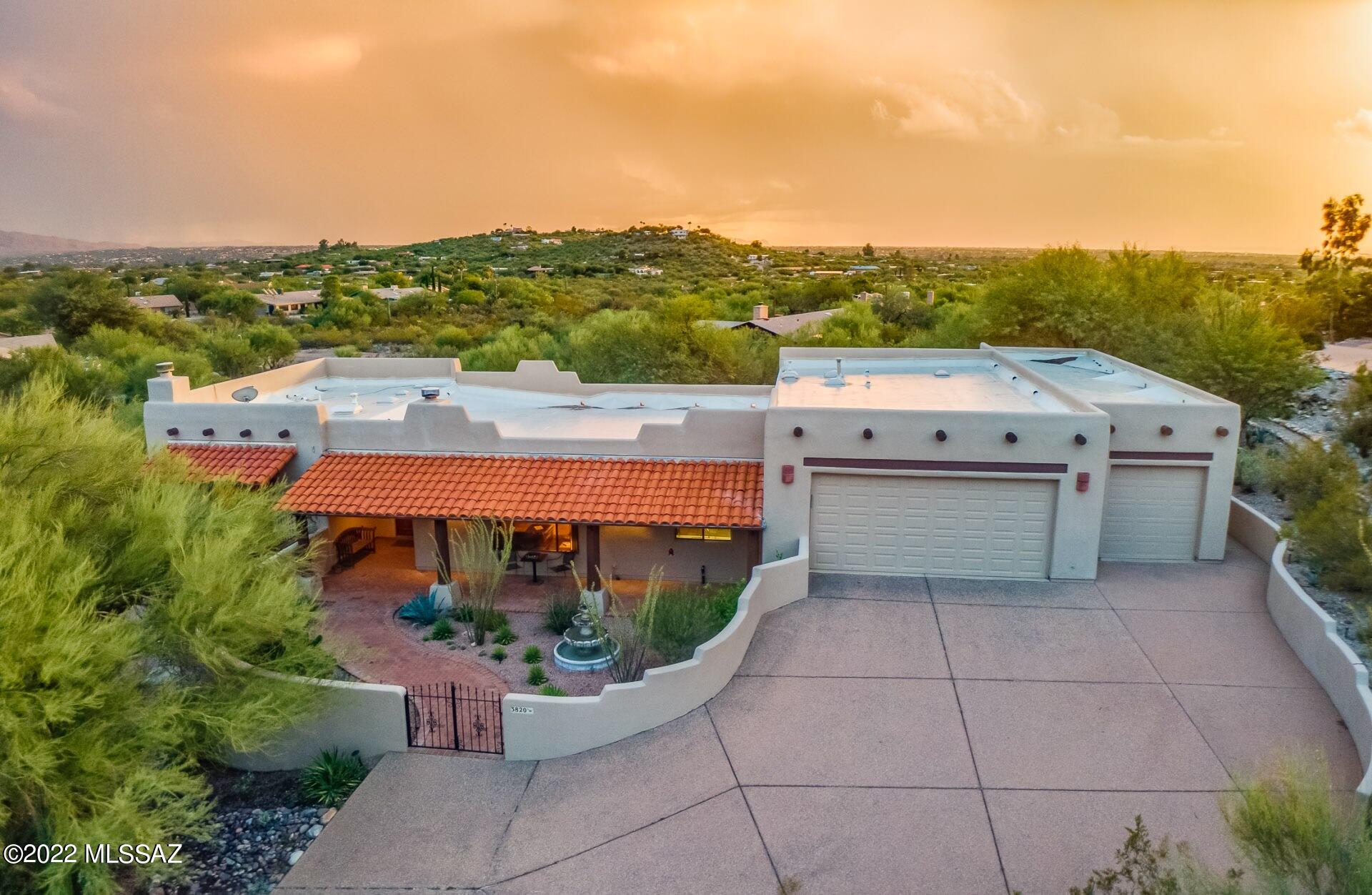 VIEWS: Mountain, Sunrise, Sunset, City Lights are plentiful from the interior and exterior of this sanctuary. Built into the hillside at the end of a cul-de-sac, this lovingly maintained 3BR/3BA Santa Fe split level hacienda on elevated lot reflects the warmth of an old friend, with rustic charm and southwest character! FEATURES: Courtyard with fountain, N/S exposure, wood beam ceilings/posts, lap pool, split floor plan, TWO BONUS ROOMS and more! OWNER'S SUITE: Covered balcony, 2 fireplaces, soaking tub with VIEWS, separate shower, dual sinks, walk in closet. *Lap Pool*  LOCATION: Situated in NE Tucson on 1.017 acres in Catalina del Sol, near Mt Lemmon. Enjoy the magic and live like a true desert dweller! THIS IS A MUST SEE!!!