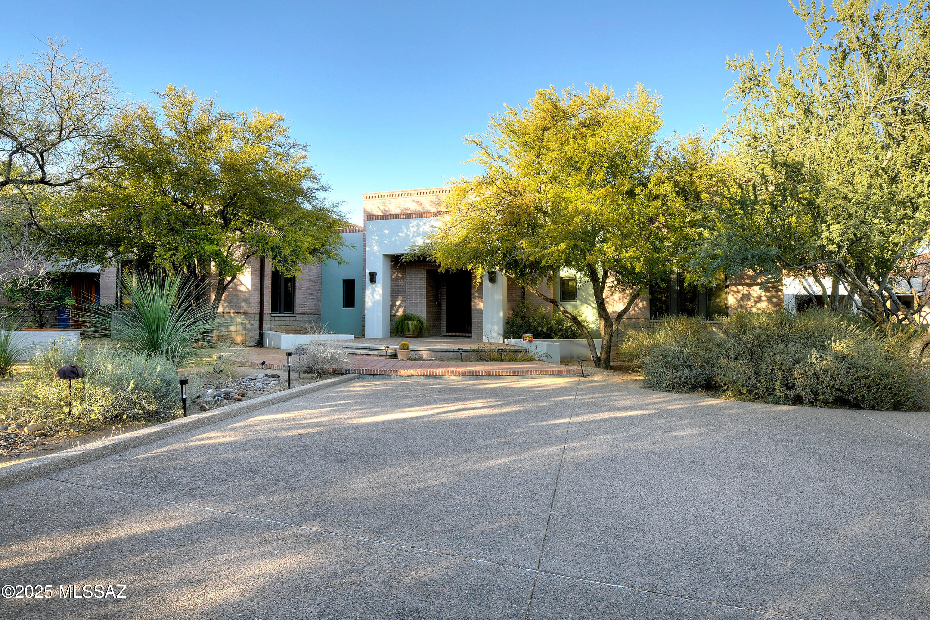 Majestic masonry estate on 2 lush acres just steps from the Arizona Inn.  Two dedicated bedrooms, attached guest quarters, and fantastic home offices that could easily convert to additional bedrooms.
