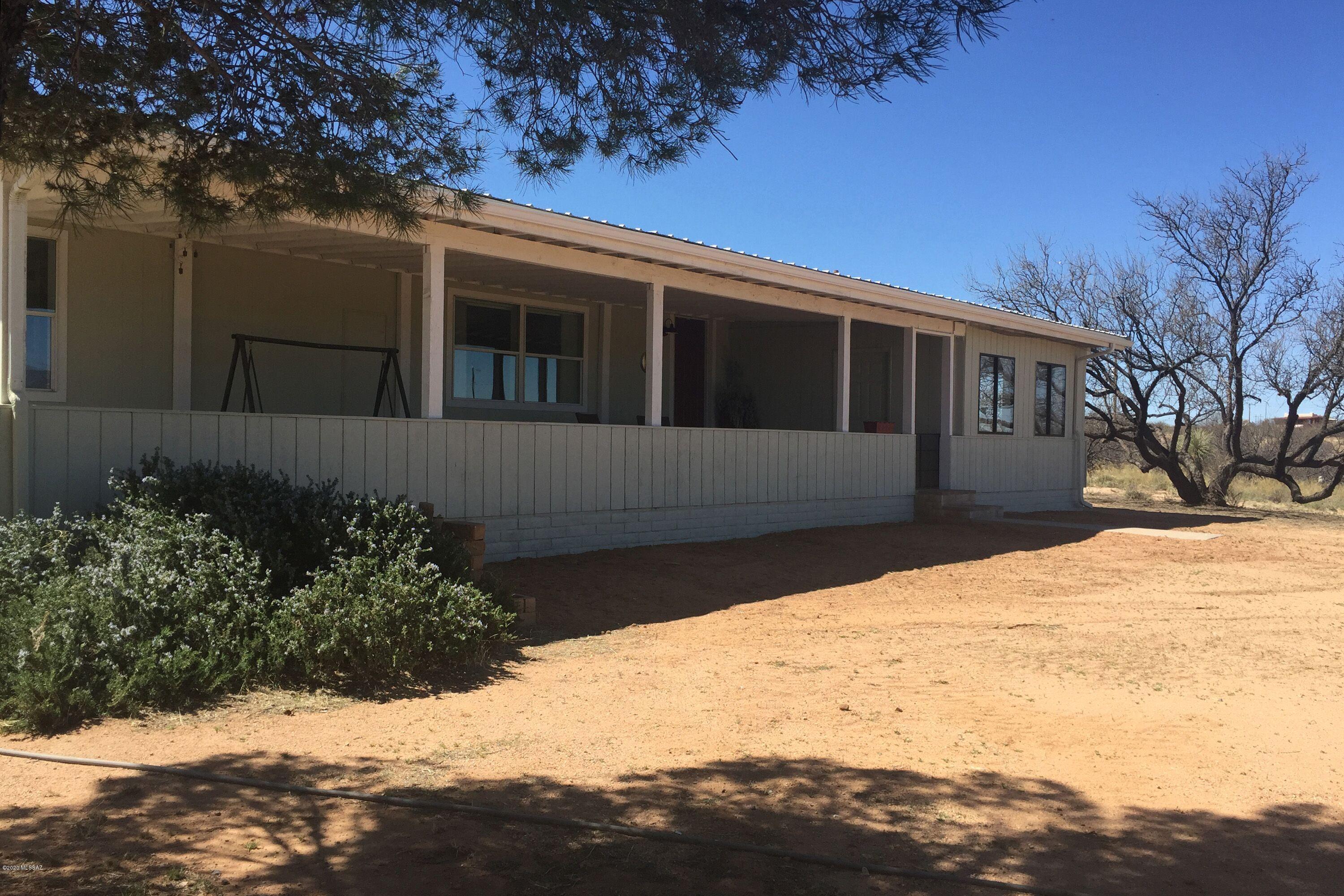 19.99 fully fenced acres with panoramic mountain views ready for horses or to just enjoy the serenity of your own private estate. Well maintained, neat and clean 1116 sq ft 2 bedroom 2 bathroom Manufactured Home with attached 12' x 14' office and a large covered front porch that is so inviting you will not want to leave. The property includes a 36' x 36' center aisle 5 stall barn w/turnouts &12' x12' tack room, 74' round pen, cement wash rack, separate 24' x 36' storage/garage building, an 8' x 40' metal storage container wired for 220, owned propane tank and 1200 gal. water storage tank with booster pump. All this minutes from I-10 for easy commute. To learn more about what this property has to offer be sure to click on documents and read the supplemental property information document.