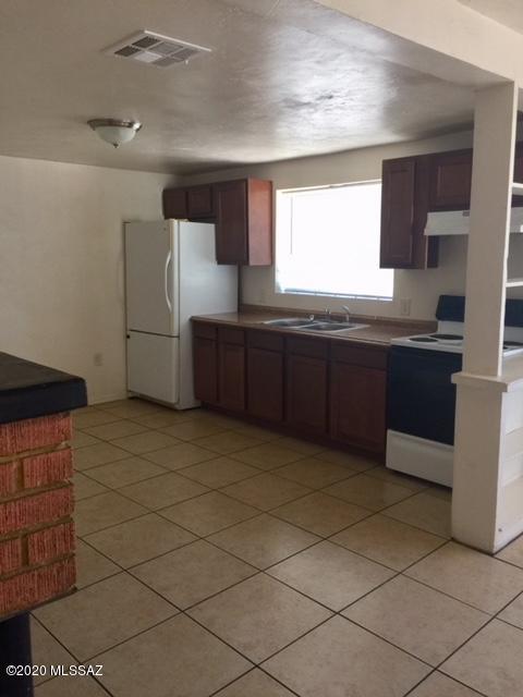 Multi unit property includes:
-1 stand alone guest house/studio- 1 bathroom, all tile floors and kitchen with fridge and electric stove. Evap cooler and space heater.  Fenced in yard, and includes storage room. *Current Tenant with month to month Lease.
-1 4 bedroom/ 2 bathroom house-all tile floors, fireplace, fridge and stove, fenced yard, outside laundry room. Central A/C and ceiling fans.
*Current Section 8 Tenant with Lease through 03/31/2021.
-1 unfinished Commercial building- half bathroom, corner lot/ good exposure- *currently vacant.
All 3 units have separate water and electric meters.  There is no gas.
Property being sold ''As-Is''.  Agent has roof bids to review for necessary roof repairs.