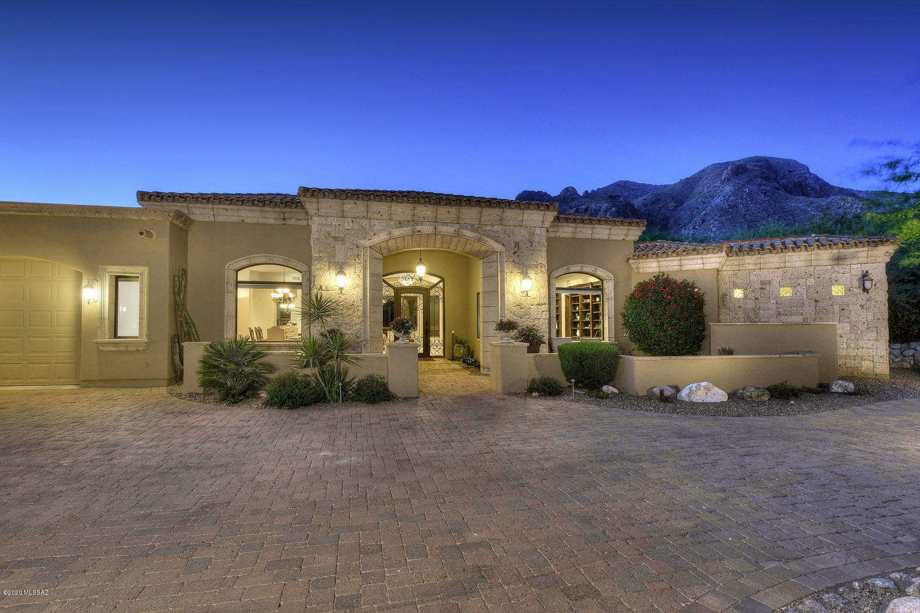 Glorious Mediterranean contemporary on stunning 1.07-acre view lot in the prestigious upper gated section of Pima Canyon Estates.  Built by master builder Wissam Kaddoura, enter into this 7,065 sq. ft., 5 bedroom plus office plus secondary family/rec room through stately wrought iron front door, into living room with walls of windows, soaring ceiling and ''reach out and touch the mountains views''; and fireplaces in the living and family rooms.  Attention to detail, craftsmanship and quality, travertine floors, 8' alder doors, gourmet kitchen with stainless steel appliances, granite counters, expansive center island and adjacent family room.  Gracious master suite offers fireplace, dual vanities, spa tub and dual walk-in closets.