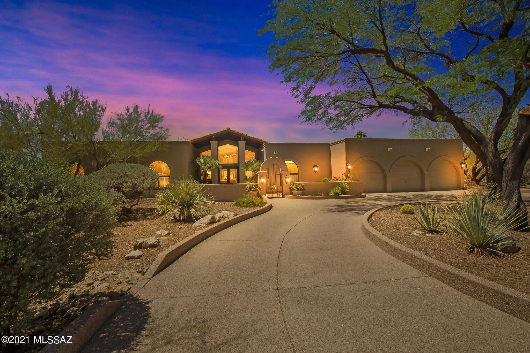 Imagine spectacular sunsets & mountain views. Set in the coveted area of Ridge Estates within the guard gated community of La Paloma. This custom built contemporary home designed by Gary Almi, embraces the Southern Arizona lifestyle. Rich and lush landscape blends with dramatic, open interior spaces. Over a 1/2 acre, and sited North/South, creates strong spatial connection with the surrounding landscape.

Enter the home's welcoming courtyard, one is greeted by a light-filled and easy-living floor plan. The main foyer opens onto the sophisticated living room featuring high ceilings, wood beams, and an expansive wall of windows, with awe-inspiring views of the Catalina Mountains, blurring the lines between indoor and outdoor spaces. Formal celebrations in the living and dining rooms, or casual gatherings in the great room or on the many covered patios, is an entertainer's delight. The chef's kitchen has custom cabinetry, ceasarstone counters, center-island, walk-in pantry & appliances for the gourmet cook. Primary ensuite showcases beautiful custom cabinetry, walk-in closet, oversized walk-in shower & private entrance to backyard

Entertain in the expansive backyard, with built-in gas fireplace, covered Ramada with custom awning provides plenty of shaded outdoor living space. 

This location places you close to the finest restaurants and shopping. With easy access to all there is to see and do in Tucson.
