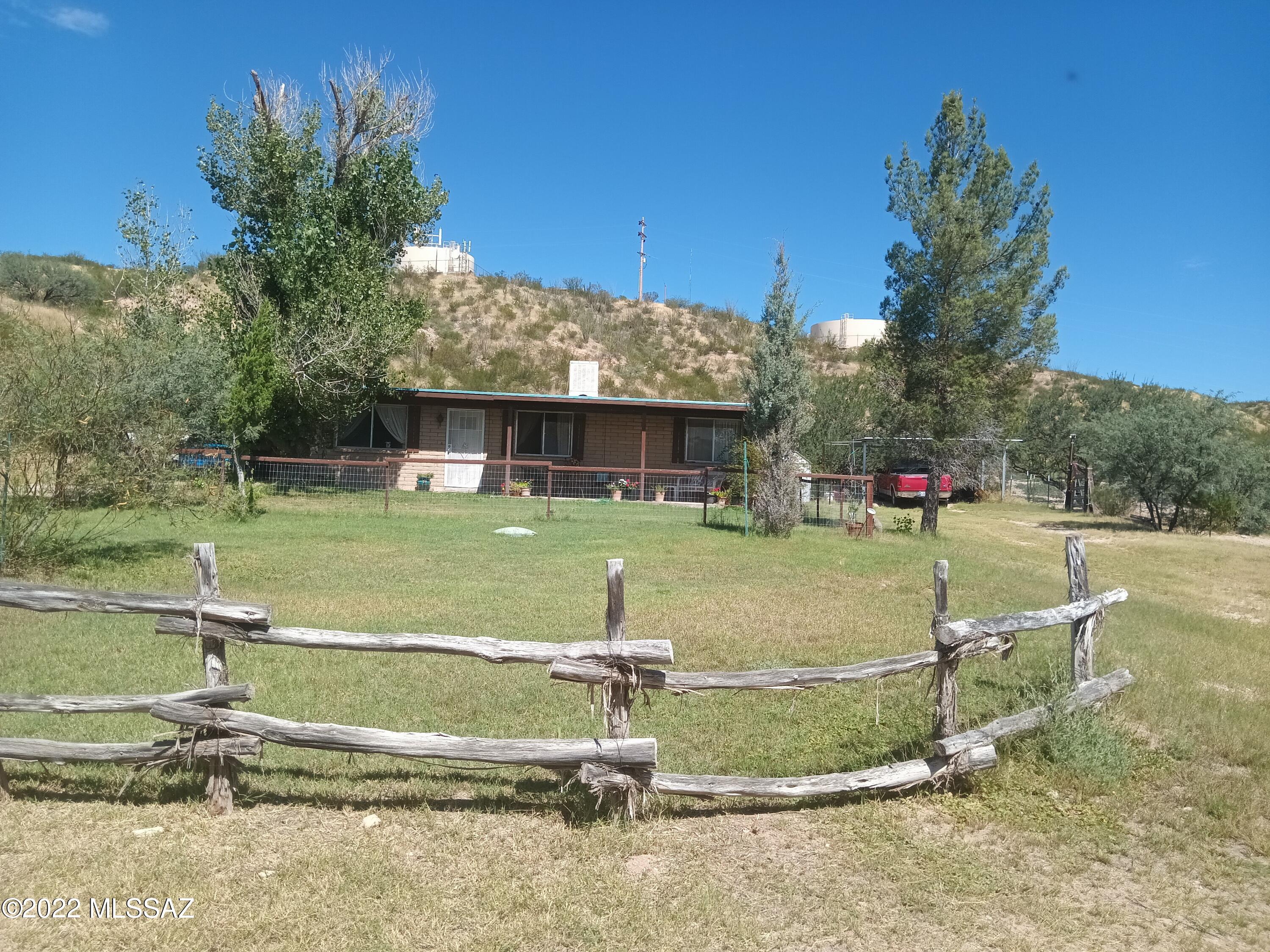 Enjoy the peace and tranquility of this charming 3 bed, 2 bath horse property on 2 lots at the end of the hard surfaced road.  This easy to maintain home allows time for other activities!  Enjoy your morning coffee on the front patio.  You can relax and grill out or just enjoy the spa on the back patio at the end of the day.

There's room for several horses and this is one of few properties that will allow unrestricted access to the Dragoon Mountains from beautiful St. David!   The area is fenced, crossed fenced, has several shades, and a total of five sheds for pleanty of storeage.  All of this and it is conveniently located approximately 7 miles from Benson's shopping district.
