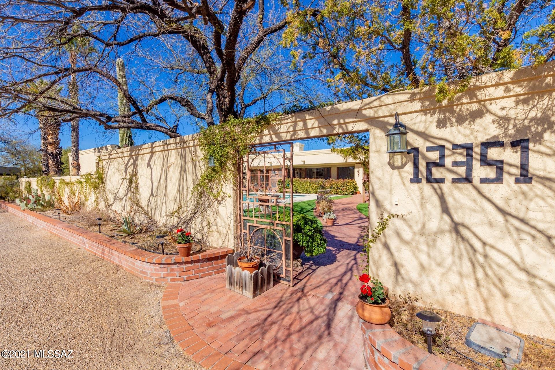 This gorgeous .88 acre homestead with expansive mountain views features a custom built 3441 sqft 4 bdr plus study/office, 3 bathroom main house and an 800 sqft casita. The main house and casita are oriented around the sparkling 20'x40' pool with desert landscaping- great for entertaining or  just relaxing.  The entire courtyard is walled, offering privacy and seclusion. In addition to the generous living spaces and abundant  storage areas this property offers covered patios, an attached 2 car garage, a detached 3 car garage, and a unique horse stable structure with endless possibilities. Tee time at 49rs golf course is moments away, as are sought after Tanque Verde School District schools. No HOA. Truly a classic desert retreat you won't want to miss!