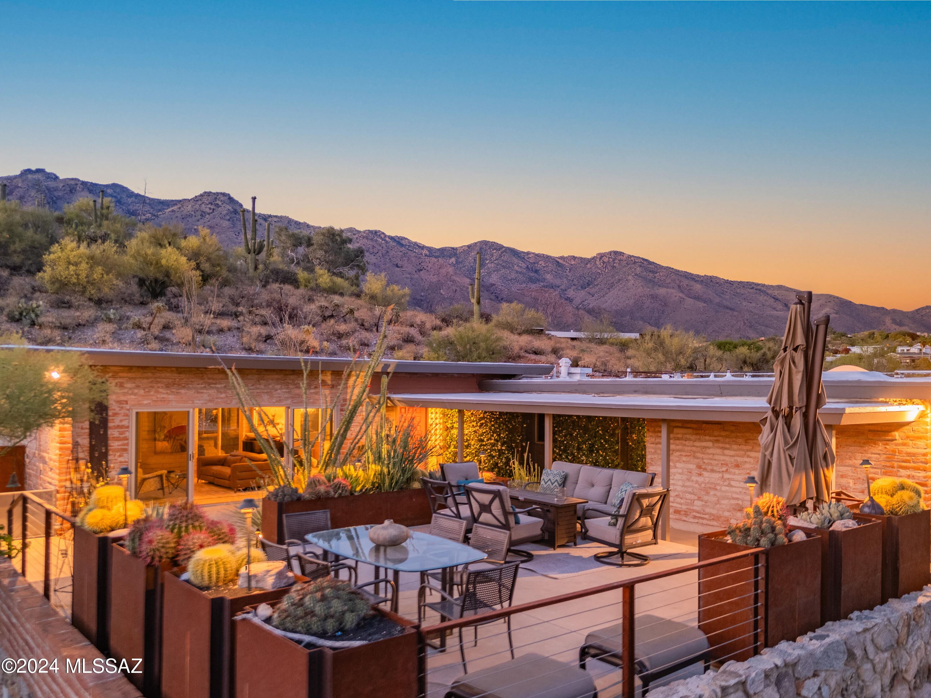 The One You've Been Waiting For!  Set back on a quiet cul-de-sac, this meticulously remodeled mid-century gem exudes elegance, sits on a perch that boasts breathtaking city and mountain views and transports you to your own private Shangri-la!  You are greeted by the front yard oasis, featured in Tucson Lifestyle Feb 2023, built atop the stepped elevation of the garage, ideal for outdoor dining and entertaining.   The home, flooded with natural light and picturesque views, offers a spacious, and intentionally airy layout.   As you enter the foyer, the living room beckons and the boundary between indoors and outdoors fades as you open the oversized 4 panel sliding doors to the front yard oasis.  The adjacent dining room and thoughtfully planned large kitchen provide a seamless flow. This is the kitchen of your dreams, featuring a convenient breakfast counter, an abundance of wenge colored cabinets for all of your storage needs, stainless steel appliances and concrete counters.  Retreat to the spacious primary ensuite with sweeping city views.  Access its private deck via the 4 panel sliding doors.  The adjacent ensuite bath with dual walnut vanity and quartz counters, boasts limestone tile, a soaking tub with designer wallpaper mural as well as an oversized enclosed glass walk-in shower.   The primary ensuite also includes a substantial walk-in closet with built-in shelves, cabinets and efficiently stacked washer and dryer.   The two additional bedrooms are generously sized and share another tastefully appointed bathroom with dual chestnut vanity, quartz counters and walk-in shower.  Discover the perfect blend of comfort, sophistication, and natural beauty in every detail of this Skyline Bel Air home.  Plenty of parking for your guests.  Steps from the community pool, tennis courts and close to shopping, dining and nature trails!  Welcome home!