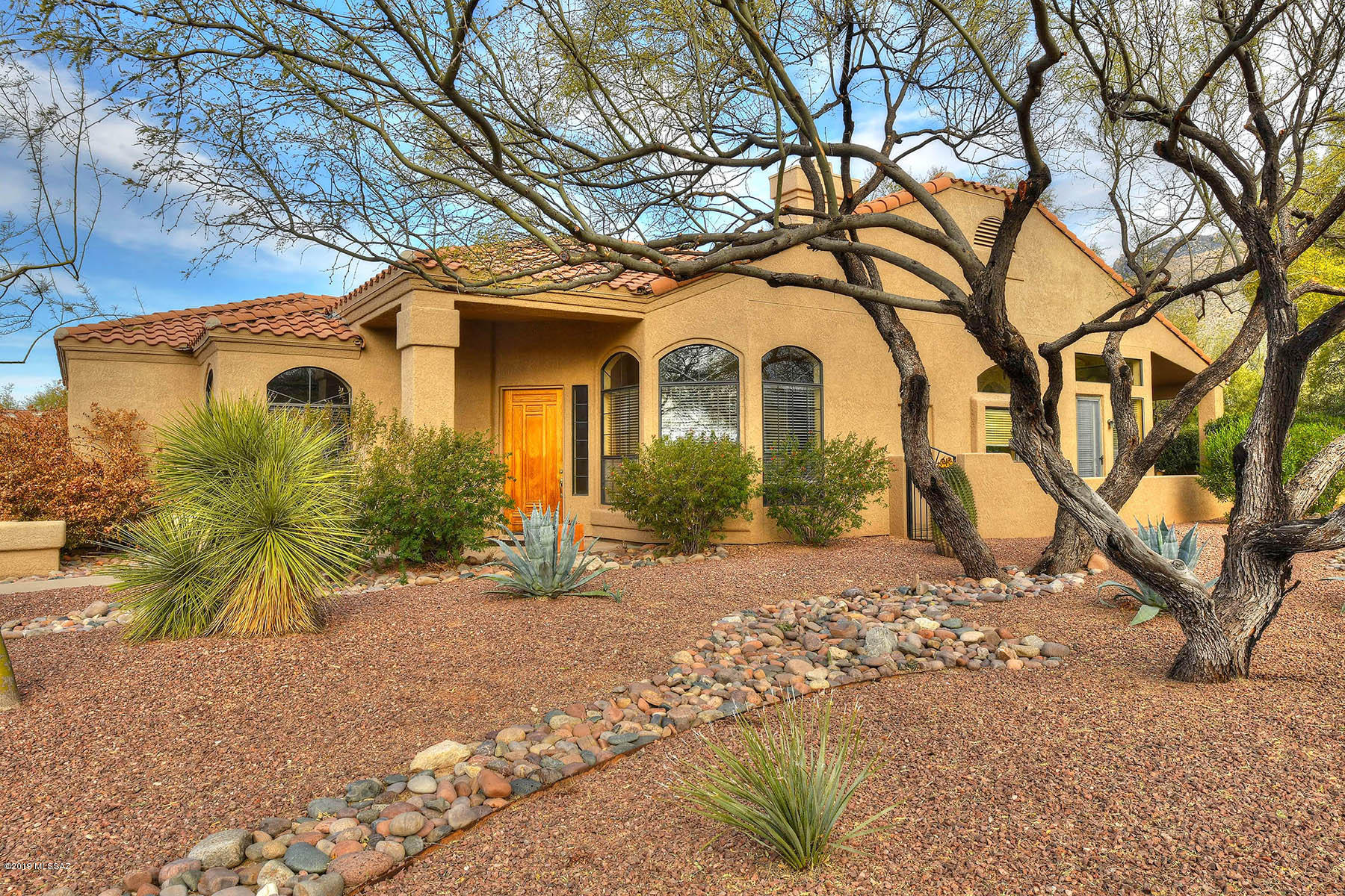 Rare Find! Beautifully Updated through out 2 bed + large den, 2.5 bath Golf Villa in prestigious Ventana Canyon. Fabulous Catalina Mountain Views. Designer touches highlight 2226 sq.ft. corner lot, beautiful window coverings, open floor plan w/ soaring ceilings. Enjoy fireplace in great room & wonderful open layout. Eat in Kitchen leads to the expansive outdoor living & covered patio, mature pretty landscaping, perfect for gatherings of all kinds. In the kitchen you won't be short of any storage, multiple drawers & cabinets, stainless steel appliances, gas range & gorgeous double corian counters. Floor to ceiling windows. Large master suite w/ access to patio + bath  w/ granite counters, double sinks, jet tub, large glass shower, & walk-in closet. Community Poo&Spa. Most furniture conveys.