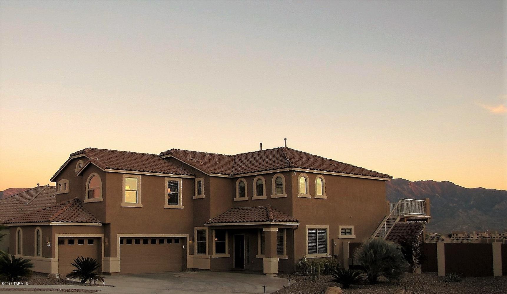 VIEWS! Beautiful 5Bedroom with spectacular views of the Catalina Mountains & city lights. Graceful elegance greets you at the tile mosaic entry, past the Piano Room & Formal Dining into the Living Room w/ vaulted ceiling, & gas fireplace. A Chef’s Kitchen w/ cherry cabinets, granite counters, SS appliances, double ovens. The 1st floor Guest Room is located next to a full bathroom. The 2nd floor (w/upgraded stair/loft banisters) has 4 large BRs & loft. Upgrades include extensive exterior/interior lighting, window coverings, cabs/counters in bathrooms/laundry.A custom deck runs full length & delivers the best views in Tucson. Tiled patio, storage room,& palm trees/citrus add to the oversized lot. The 3car garage has epoxy floors, custom paint & central vacuum. Not your average home-must se