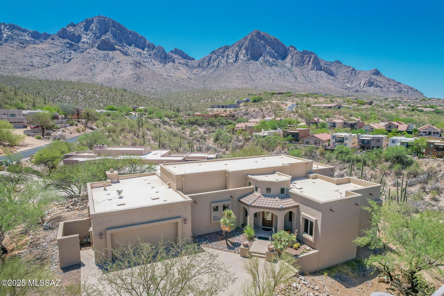 Exceptional 3BD/2.5BA +Den (2,858 sf) estate within the private, guard gated Wilderness Estates at La Reserve affords a striking Pusch Ridge backdrop plus spectacular mountain, valley & sunset views! Welcoming corner lot home on cul-de-sac street is situated on .60 acres and set back from the road. New Exterior Paint! This idyllic home showcases an Owner's wing with den/office (potential 4th bedroom) plus Guest wing with bedroom, hall bath and additional bedroom or den/office. Enjoy soaring, recessed and vaulted ceilings, formal living/dining room with walls of windows accenting the views, plus large Family Room off kitchen with corner kiva fireplace and wall-to-wall media center. You'll be greeted by a long driveway and dramatic circular foyer accented by soaring clerestory windows, chandelier and overheight entry door with beveled glass. Elegant Owner's suite with vaulted ceiling accesses main & side patios and hosts a spa-like bath with dual sink vanity, relaxing 'air bubble' soaking tub, glass block & tiled walk-in shower plus custom walk-in closet. Striking gourmet kitchen with vaulted ceiling and skylight hosts a diagonal set island, breakfast nook with views, Sub-Zero fridge and Dacor gas range, prep sink, plus built-in workstation and pantry. Additional amenities include skylights, art niches, clerestory windows, granite countertops in kitchen & baths, elegant powder room off foyer, extended laundry with sink, extended garage with built-in cabinetry plus zoned heating & cooling. Retreat to a serene rear setting boasting a Pusch Ridge backdrop plus covered and uncovered patios. A true desert retreat for the most discerning buyer!