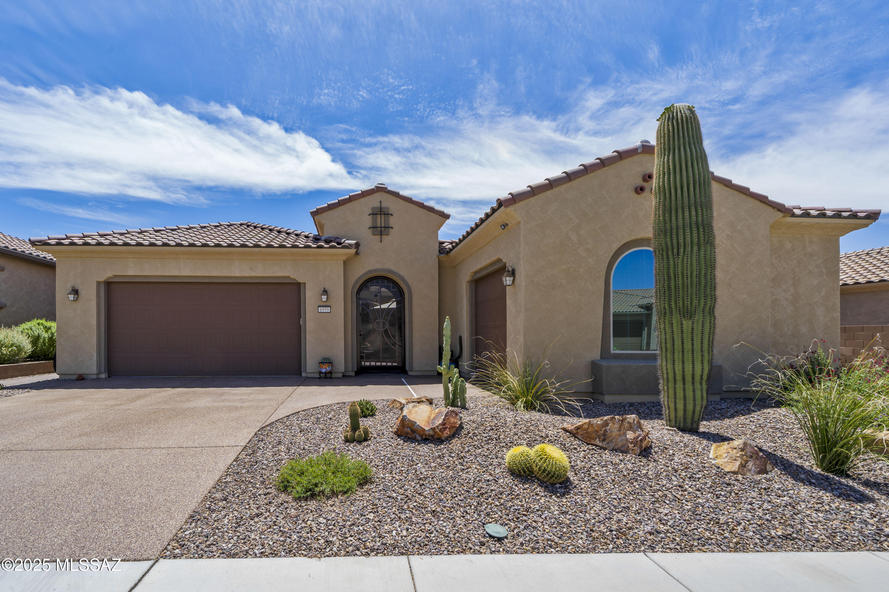 Beautifully upgraded Journey model featuring an inviting paver courtyard with a tranquil water feature and a custom iron entry door. Inside, you'll find a private guest en suite with its own living area—perfect for visitors or multigenerational living. The luxury kitchen is a chef's dream, complete with a large island, quartz countertops, upgraded cabinetry, stainless steel KitchenAid appliances, a walk-in pantry, and a built-in coffee bar. The spacious primary suite offers a spa-like retreat with an oversized walk-in shower, built-in seat,rain showerhead. Classy Closet custom built-ins in the primary walk-in closet provide ample, organized storage. Additional highlights include an upgraded laundry room with a sink and cabinetry, a 2-car garage plus a separate 3rd car garage, insulated doors, and Galaxy coating on the garage floors and driveway. This home also features a tankless water heater and an Aquasana water filtration system. Step outside to a southeast-facing backyard with an extended pergola for shade, sealed pavers, low-maintenance turf, and a view fenceideal for relaxing or entertaining. No corners were cut in this home with over $40,000 in builder upgrades. All located in a Del Webb community offering a fitness center, pool, spa, tennis, pickleball, bocce ball, and a variety of social activities.