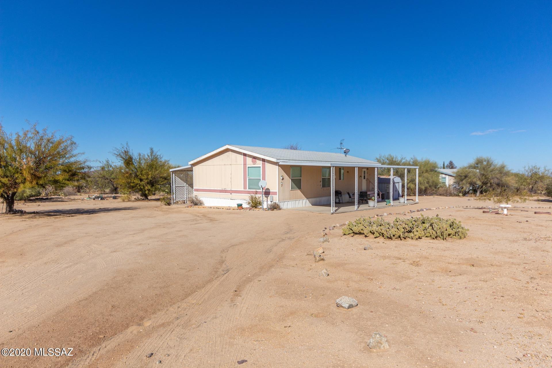 Fantastic Home & Horse Property on an acre of land w/Pride of Ownership throughout. Mountain & desert views, covered patio entry, & 2 storage sheds. Plush carpet, soothing palette, ceiling fans, vaulted ceilings, & window blinds.  Spacious eat-in features plenty of wood cabinets, breakfast bar, & stylish counters. Interior laundry room w/storage cabinets & yard access. Generous size bedrooms, ample closets, & 2 pristine baths. Extended covered patio & space for all your toys!!  Very private setting. Legal Description: 301741250 /N Ctrl Ptn E2 S1/3 Lot 13-6 Rancho Sierritas Rs 1/85 Aka N219.77' W198.21' E396.40' E2 S1/3 Nw4 Se4 1 Ac Sec 13-16-10