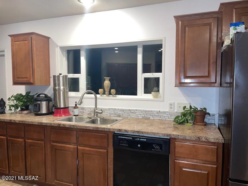This 3 bedroom, 2 full bath home in a desert setting has a new roof both on the house and a large storage shed/playhouse in the back yard. Cherry cabinets, built-in oven and microwave, flat top electric range, built-in desk in kitchen. Seller has repainted the kitchen and put in new flooring in the family room. Property fenced with many fruit trees, garden area, right off of a paved road. It's a must see! At this price, it won't last! Seller will entertain VA, CASH or Conventional loans.