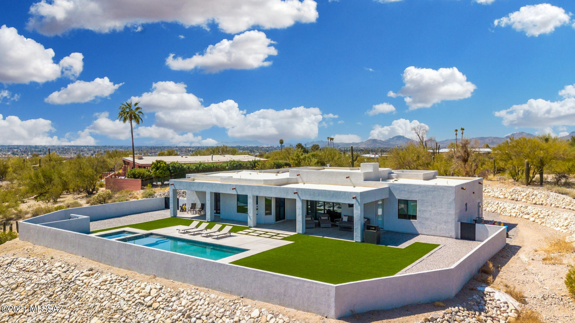 Stunning Modern Foothills home newly built in 2019! Perched high on a hilltop taking in unobstructed mountain & city views! Completely private backyard w/ PebbleTec pool & spa. Huge covered patio & optimal sun orientation, perfect for entertaining year round. Open floorplan w/ expansive glass slider in great room for great indoor/outdoor flow. Gourmet kitchen w/granite counters, upscale stainless appliances, huge island, floating shelves & coffee bar area w/ice maker. Carrara Marble counters in bathrooms & Master Shower. Concrete floors throughout, no carpet! Split floorplan w master, laundry & garage on one side & 3 bedrooms on other side, one which is a mini-master w/ its own ensuite full bath. Den/dining room currently used as play room. Newer, modern, views...all around perfect house!