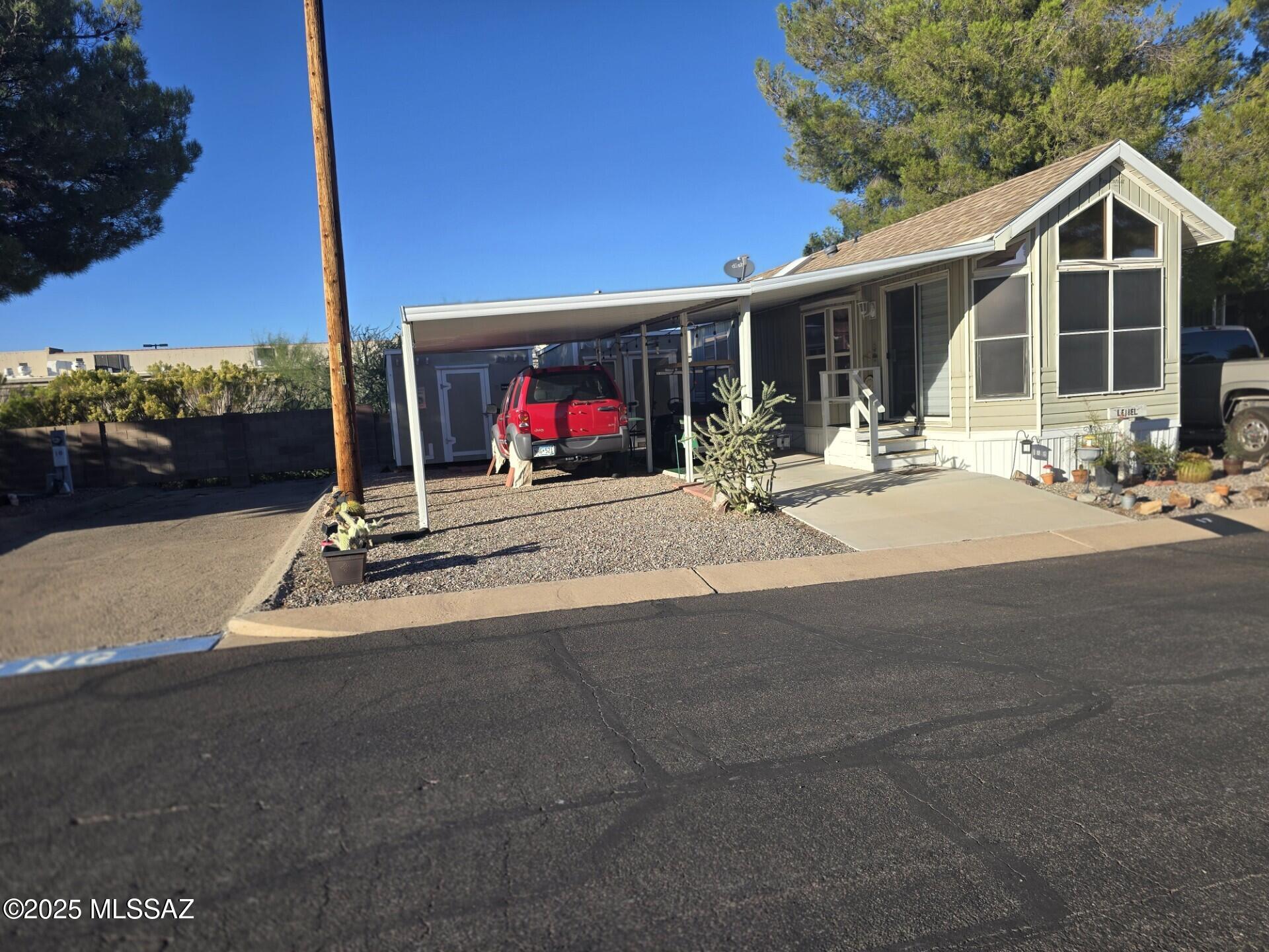 Fully furnished Park Model that includes dishes, pots and pans, all kitchen appliances, etc.  Two car carport and two sheds, one that is used as living space with refrigerator, furniture and TV, and second is storage.  Cozy little back patio.  Park is conveniently close to shipping, medical services, restaurants, etc. Park amenities include wide streets, wood shop, library with computers, WIFI, Pool and Spa, Fitness Center, Putting Green, Laundry and small observatory. This is a lease hold park model in RV park. Buyer must apply to Butterfield RV Resort to rent lot. Lot rent is $395.83 monthly.