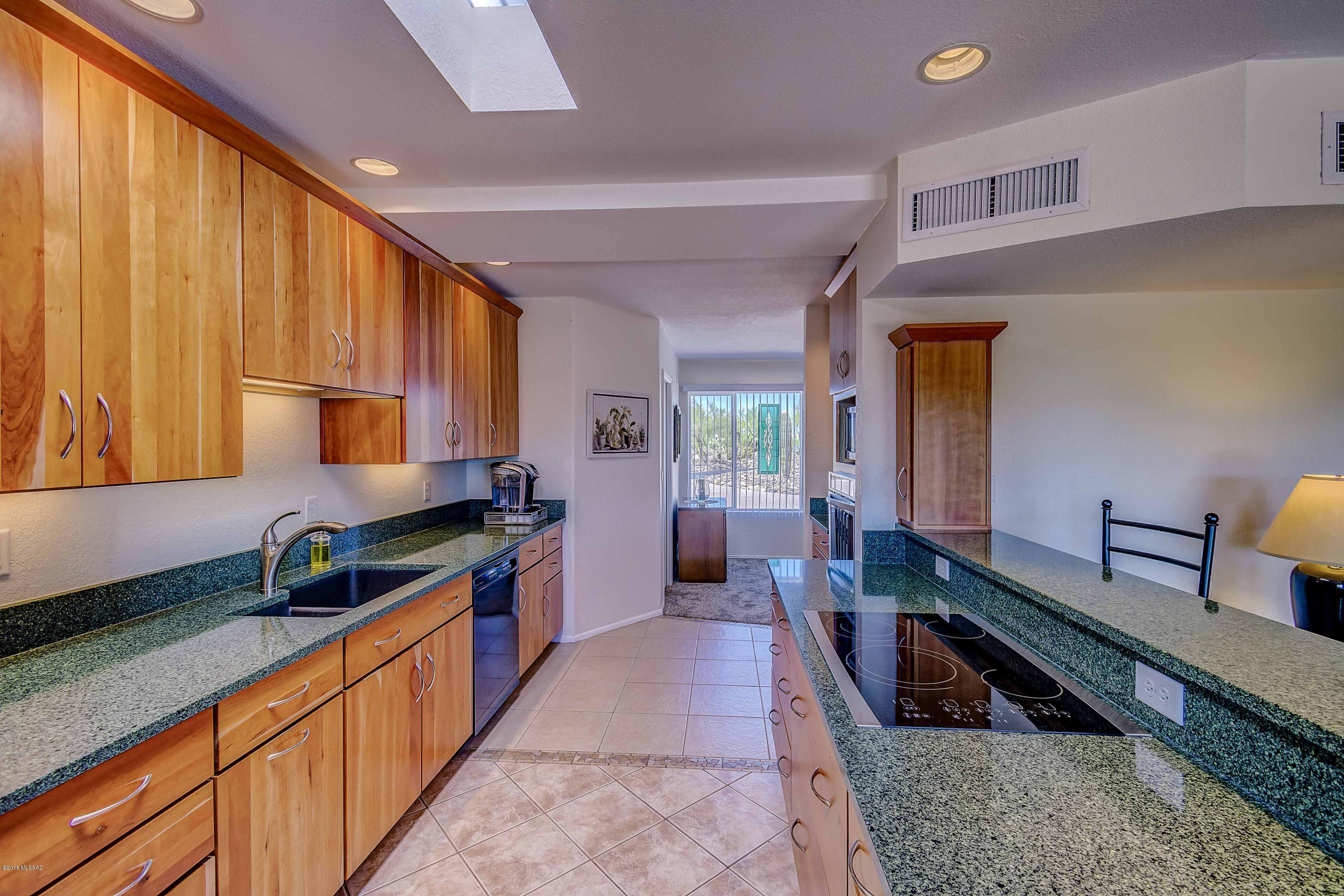 This meticulously maintained, lovingly updated 3BR, 2BA territorial home sits on elevated lot in highly desirable Casas Adobes, featuring majestic mountain views against a saguaro studded landscape. Indoor/outdoor entertaining spaces with covered patio leads to backyard, starring a STUNNING fully fenced, newly renovated pool highlighted by a laguna/shamu shelf. Enjoy Catalina Mountains views by day and star lit desert skies at night. Inside: Your inner celebrity chef will enjoy this immaculate kitchen furnished with quartz countertops, Medallion Designer cabinetry and stainless steel appliances. Master Bedroom Retreat offers both a newly created ensuite bathroom with designer shower and large walk-in closet. Backing up to Greenbelt area = PRIVACY.  NO HOA ***MORE DETAILS ATTACHED***