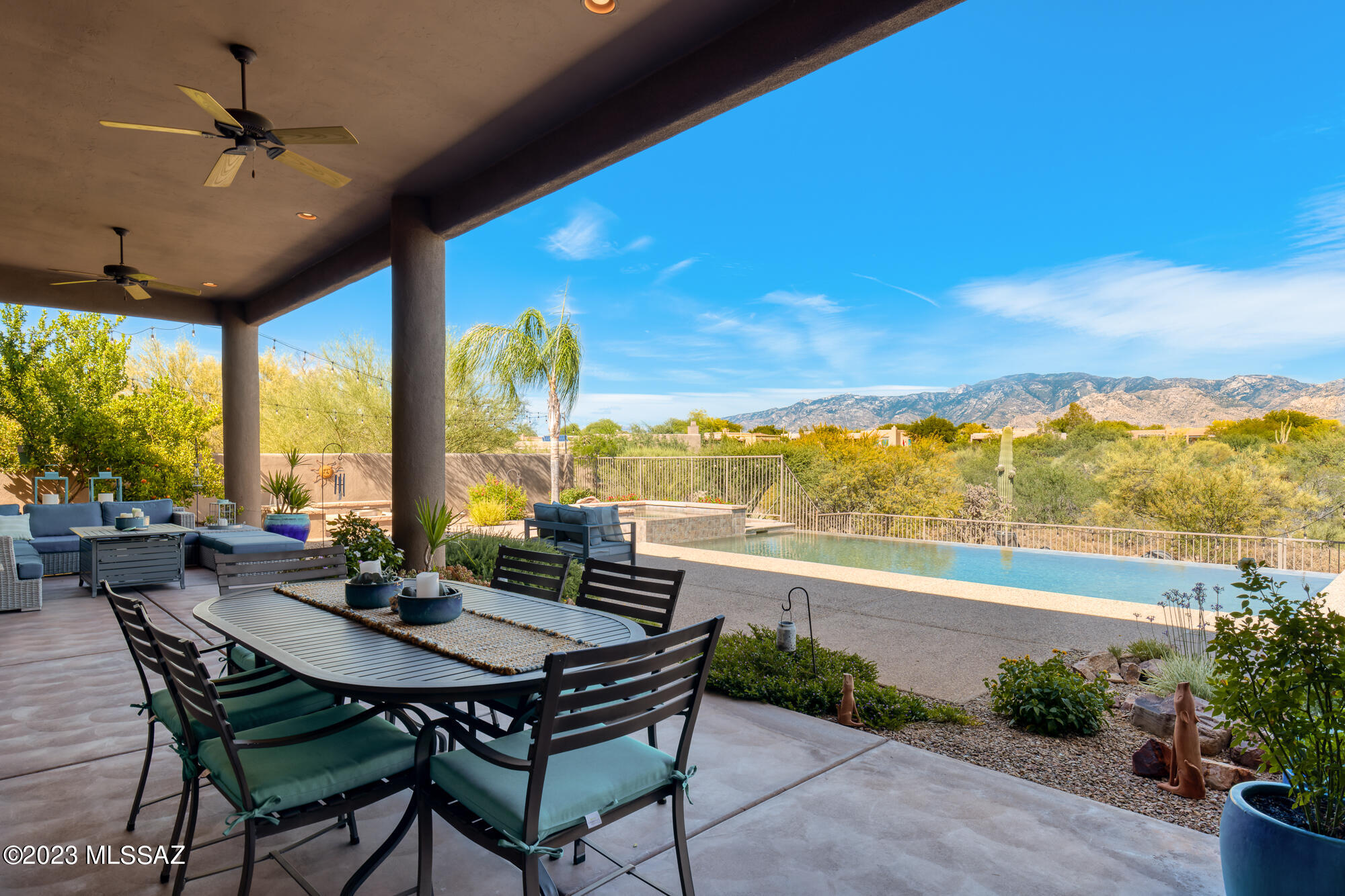 Panoramic Catalina Mountain views! Modern great room style Oro Valley residence with sophisticated design and amenities. Open and bright with 3 bedrooms, den, powder room and office. Great room with high ceiling, wall of windows and inviting gas fireplace. Chef's kitchen with bar counter, island, walk-in pantry and wine bar for relaxed entertainment plus spacious dining nook, all with awesome Catalina views. Primary suite with large bath vanity counter, walk-in shower and jetted tub plus direct access to rear patio. Two additional bedrooms share shower bath but have separate private vanities. Gorgeous yard with long & deep covered area for dining or relaxing. Extended paver patio with negative edge pool, spa, built-in BBQ and firepit for outdoor enjoyment. Circular driveway & 3-car garage!
