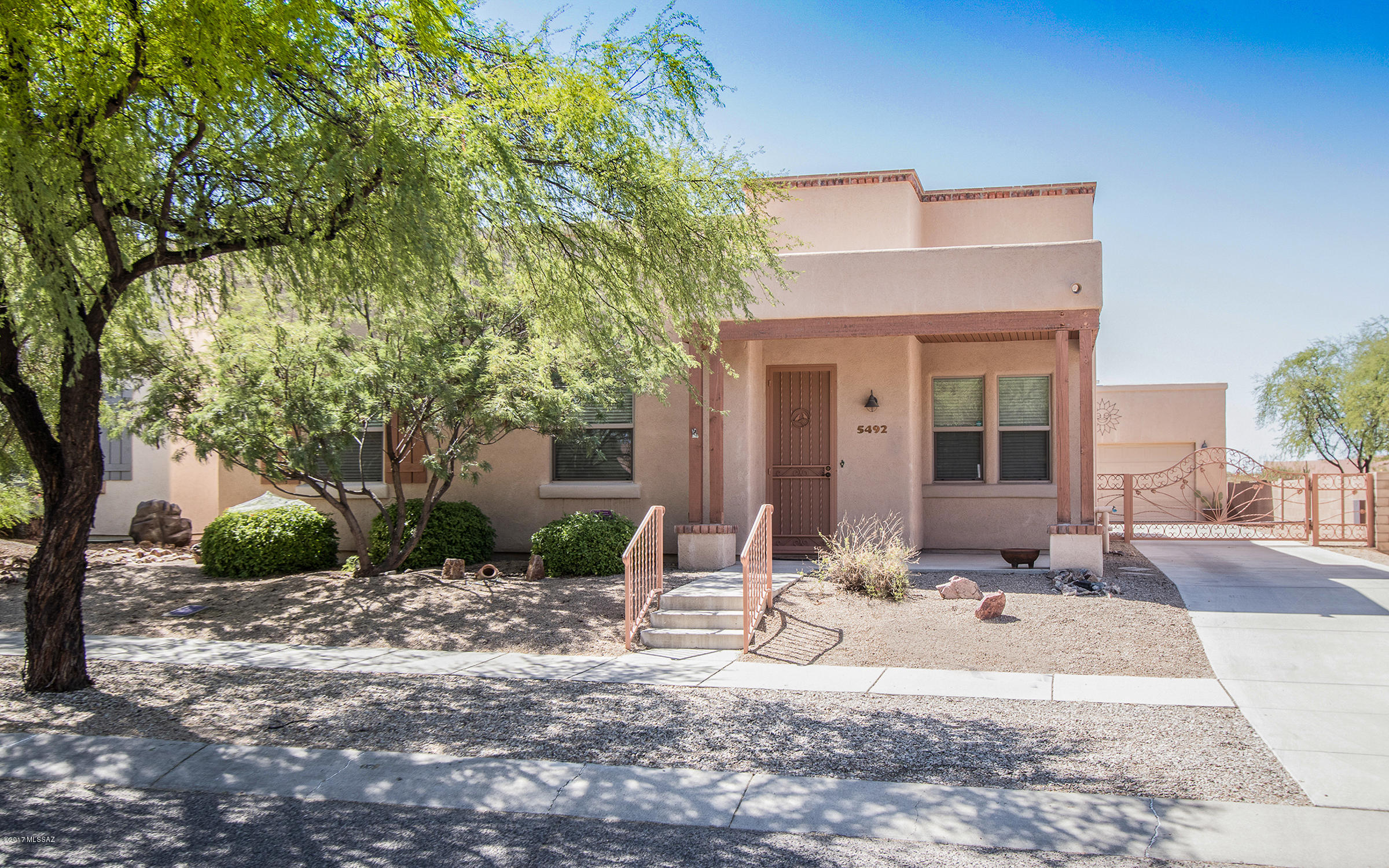 Desirable floor plan in Civano. Home backs up to wash/green space. Beautiful desert views!  Home features 2 bedrooms, 2 bathrooms and a Den. Open floor plan between great room, kitchen and dining area. Kitchen has large island and plenty of cabinets; counter space and pantry. Tile flooring in kitchen and master bathroom. New dual sink, executive height vanity in master bathroom. Garden tub and separate shower. Security doors on front door, sliding glass door and door from master bedroom to back porch. Washer, dryer and refrigerator included. Solar water panel for reduced energy costs. Solar powered driveway gate for added security. Large lot with a beautiful mature palo verde in the back yard. You must see this home, it won't last long!