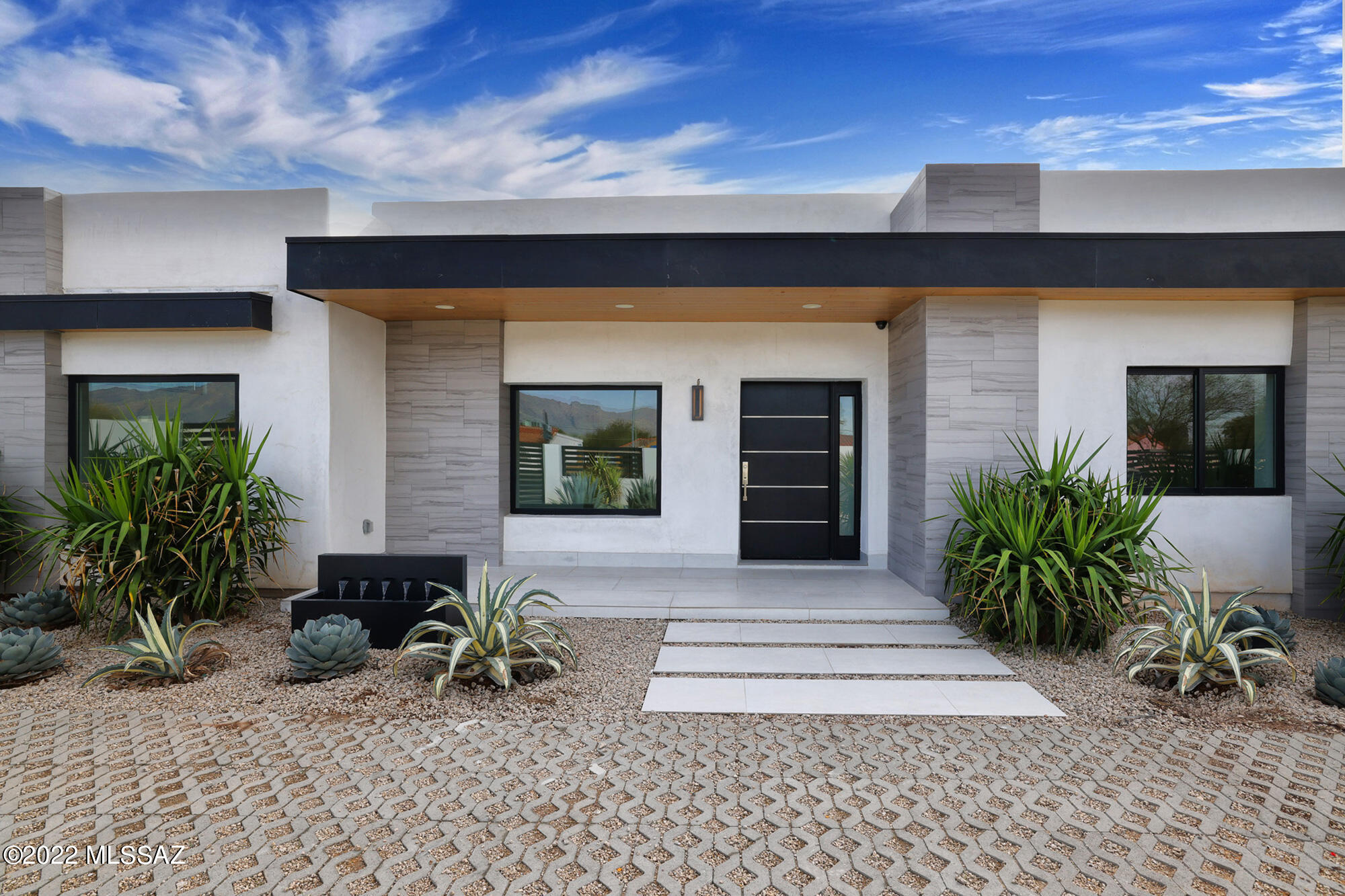 TOP OF THE LINE full renovation with imported materials from CA.  Beautiful, spotless, ahead of its time for the area. Located in central Tucson minutes from the UofA, downtown, entertainment, shopping, etc. Mature landscaping with a variety of colorful desert plants & zoned irrigation. Multiple covered patios in the front & back including off the master suite. Features include large Anderson windows, recessed lighting, split floor plan w/ two master bedrooms, book-matched porcelain & quartz island, countertops & showers, dual wine cooler, wide oak, porcelain & marble flooring, Italian cabinets, SS Kitchen Aid appliances, gorgeous pool with new limestone deck. Dedicated laundry room & outdoor bar with built in grill. Designated area for custom firepit in the backyard *buyers choice - seller will pay & install!* 

Please request features list as there is way more than we can describe in this short listing!