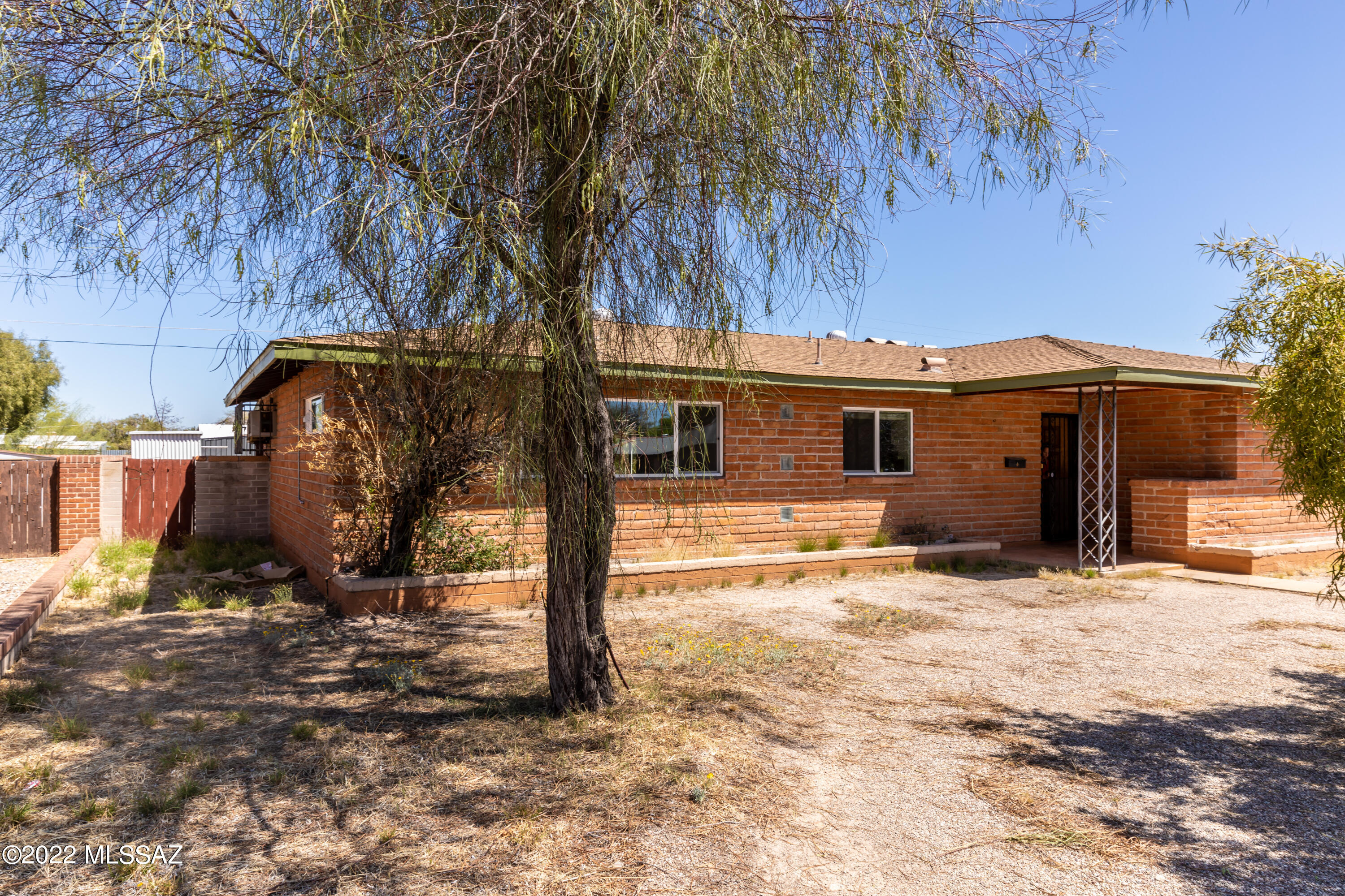 Charming adobe brick house built in the 1950's.  Large corner lot, fully enclosed backyard with mature vegetation, and great mountain views.  Located on a quiet residential street, less than a mile to the U of A and downtown.  Close to shopping and trendy restaurants.
This spacious adobe home features a large open kitchen with plenty of storage, ceramic tile throughout, and sliding glass doors that lead to the backyard. Great also for a rental property. With some sweat equity, this would make a good family home.