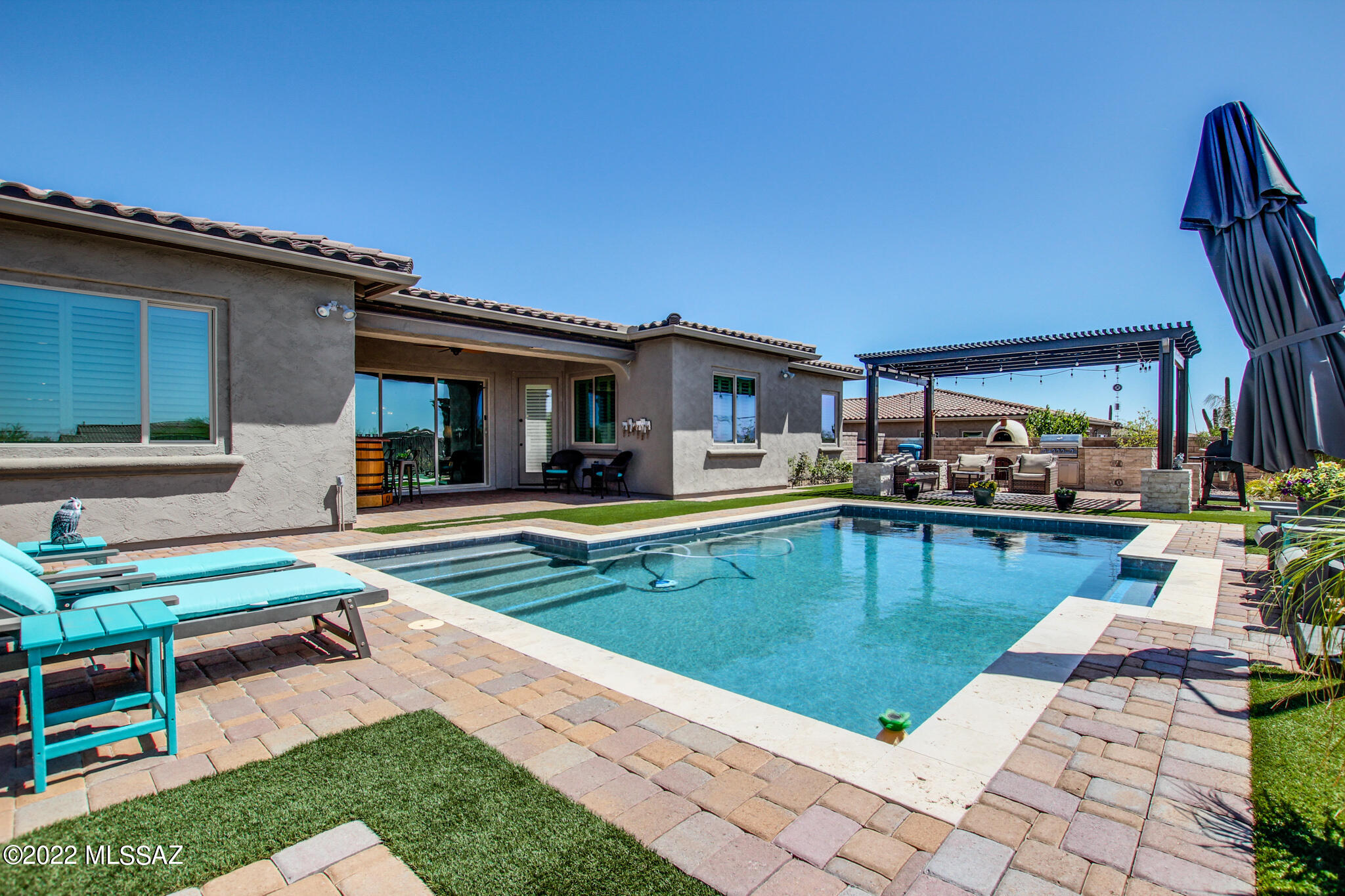 Immaculate Oro Valley Home with Custom Upgrades Throughout! Built in 2015, this home has been meticulously maintained, most recently with Fresh Paint Inside and Out. 3531 sq.ft. of Living Space, all with Tile or Real Hardwood Flooring. Additional Cabinets in the Breakfast Nook area, Extended Length Kitchen Island with cabinets on both side providing ample storage options. Extra Large Master En Suite with His & Hers closets, Double Vanities, Soaking Tuba nd Walk-in Shower. Luxurious Resort Style Backyard including Covered Patio, Sparkling In Ground Pool, Landscaped with Turf and Pavers, and completed with Built in BBQ and Pizza Oven! 4 Car Garage with coated Epoxy Flooring. All on a premium sized .49 acre lot! Sold with the Refrigerator, and TV in Master and TV on the backyard patio.