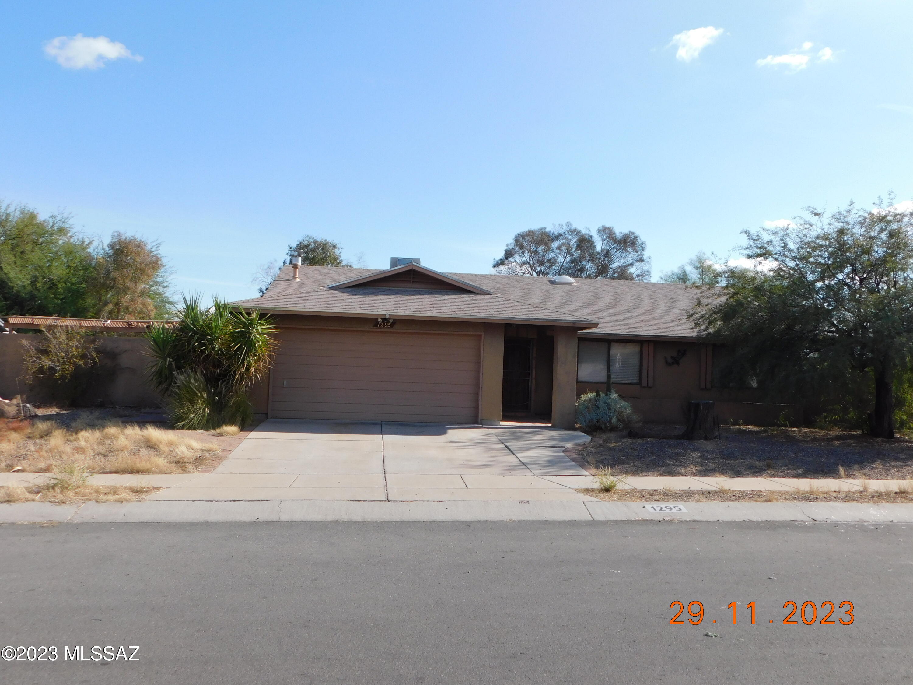 Centrally located to the I-10/I-19 freeways, this 2 bedroom, 2 bathroom single level ranch home with a pool & 2 car garage, is simply waiting for the homeowner who wants to create a newer, updated look. The bonus room, is large enough to create a 3rd bedroom, without loosing any common area space. It just needs to be enclosed. Choose your colors & patterns for new paint, flooring, and counters, and you have the makings of an updated home. The pool is due for refreshing as well. We have bids on the pool & interior painting.. Come check out what could be a relatively easy remodel.