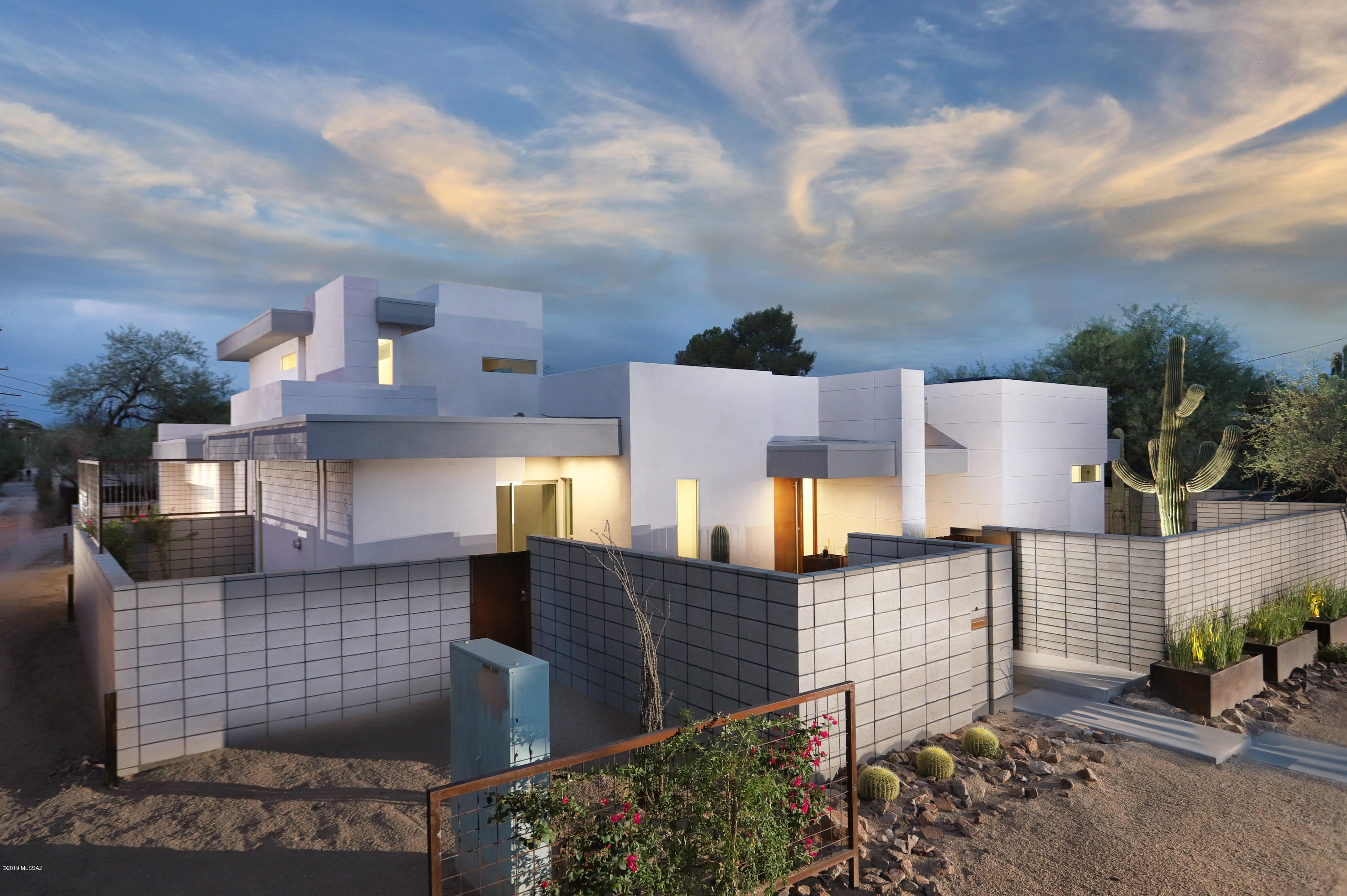 MOVE-IN READY. New Construction. Foothills Features in SAM HUGHES! MODERN gem by top Architect. it's ultra flexible & feels larger than 3400 sq. ft. No quirky spaces you can't furnish. PRIVATE & SECURE with attached 3-car garage. Every room extends into surrounding outdoor spaces. Imagine sitting in your great room looking to your private courtyard with a 9' fire pit anchored by a Saguaro & tranquil fountain... turn & glance through your telescoping 10' tall sliding glass wall to enjoy your oversized patio & expansive backyard that's made private with 10' CMU & trellis walls with vibrant vines. Your dream kitchen is loaded with a chef's pantry, command center & the most inviting & functional working island. Detail & excitement at every turn. Agent/Owner