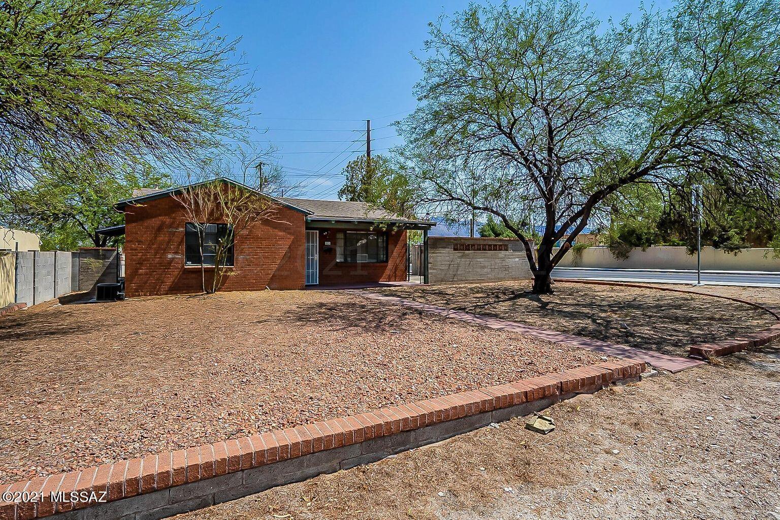 Live one mile from the University of Arizona and Banner Medical Center and less than one mile to the Mountain Ave. bike path. 4 bedroom/3 bathroom split bedroom plan: two bedrooms with private bathrooms and two bedrooms share a hallway bathroom.  Zoned AC and Heat, new roof in 2018. Kitchen features slate counter tops and GE stainless steel appliances. Family room and breakfast area off the kitchen plus an additional living room.  Large yard with block wall and solid red brick construction.  Off street parking and parking available on the property. No HOA. Work recently completed: painting of exterior trim,refinishing of the master bathtub,some interior paint,sewer work completed on both sewer lines.  Seller is including a home warranty.