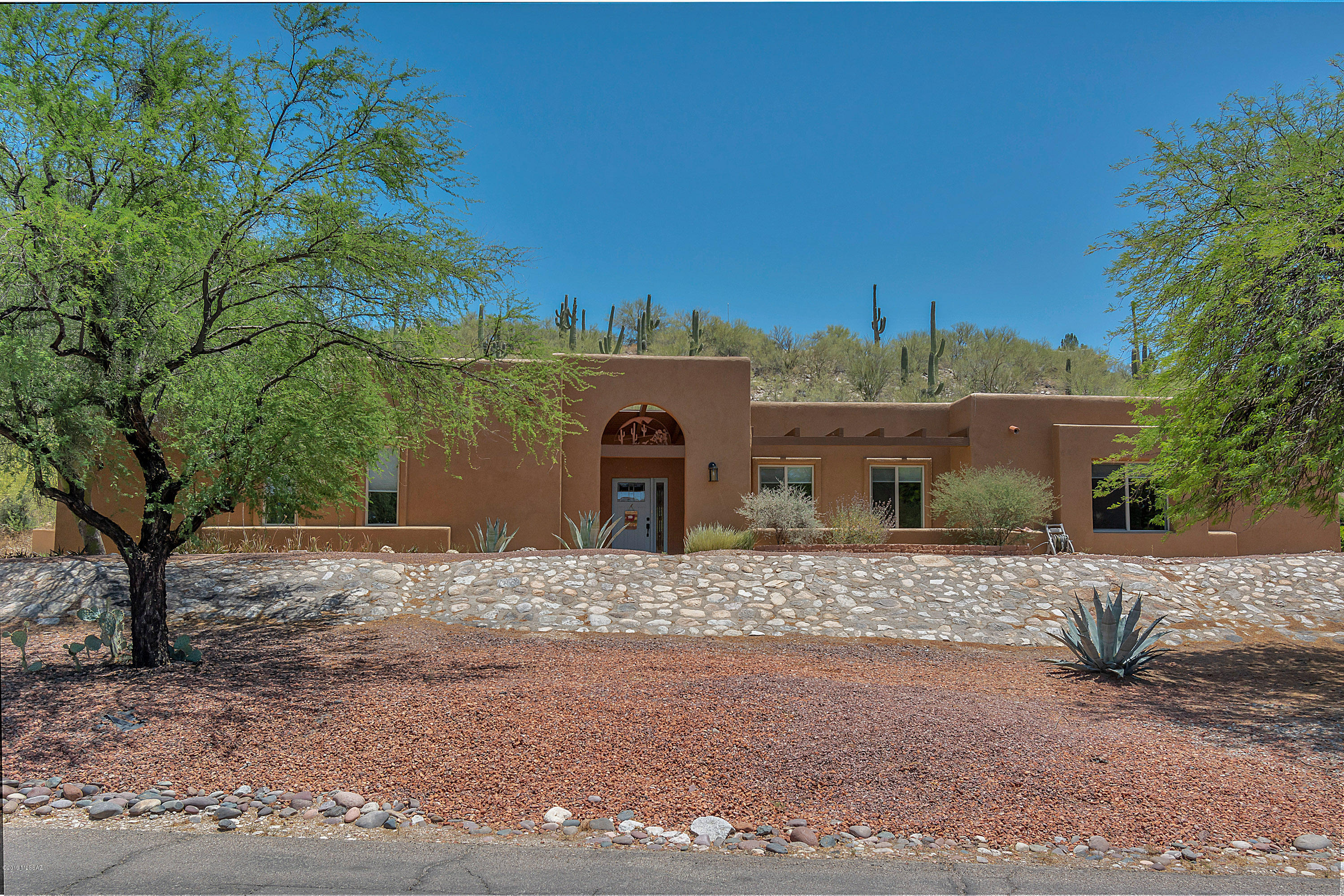 Beautiful foothills gem, meticulously maintained in a great location, & ready for your buyer. Large Mstr bedroom, big hall closet w/safe included, beautiful kitchen with island & ample hickory shelves, family room adjoining kitchen. There are Pergo floors throughout the home, formal dining room w/elegant chandelier, master bath w/walk-in shower, 2nd bath fully updated, large private patio great for entertaining with abundant desert vegetation, planters & drip irrigation, home has newer exterior paint, bedrooms have large closets w/shelves, step-down living room, no neighbors behind you, all doors redone and repainted. The garage has a large closet that could be a workshop. Washer & dryer included in the laundry room, ceiling fans throughout the house. Room dimensions available on  request.