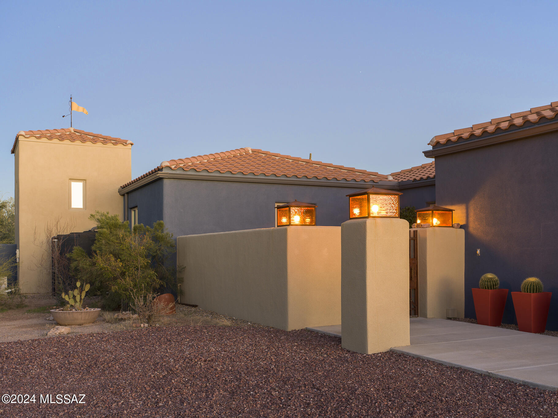 Indulge in this stunning one-of-a-kind custom residence, gracefully situated on over 8 acres adorned with saguaros, palo verde, ironwoods and mesquites. The visionary design by John Bissell, renowned for his mastery of geometry and color, pays homage to the inherent beauty of the surrounding desert landscape. 
Compression and expansion unfold as you enter the great room, where a dramatic beamed cathedral ceiling welcomes you, inviting you to experience a flood of natural light through the wall of glass, blurring the line between inside and out. Adjacent to the great room, a connected patio seamlessly extends your living space, providing an enchanting backdrop for moments of relaxation and entertaining. The well-appointed kitchen is a showcase of modern luxury, featuring stainless steel appliances, Talavera tile, sleek quartz stone counters, and an integrated bar seating area - a perfect milieu for hosting gatherings with friends and family.

The thoughtfully designed split-bedroom layout ensures a harmonious balance between privacy and communal living. The owner's suite, a sanctuary of indulgence, boasts a custom walk-in closet, a spa-like bath, and access to a private spa area to enhance the experience an oasis within your haven. On the opposite wing of the residence, a second bedroom, a full guest bath, and a spacious bedroom/library with built-in shelving provide versatility for remote work or showcasing curated collections.

Further enhancing the living experience, discover amenities such as a strategically positioned laundry/pantry off the kitchen, a 2-car garage, and an additional workspace or office adjacent to the garage. Four meticulously placed patios throughout the property offer distinct connections to the desert landscape at various times of the day.

The home's commitment to environmental sustainability is evident in its Rastra block construction, high R-value Pella windows, owned solar system, and grey and rainwater collection features. 

In 2021, the current owners added a 484-square-foot guest house that seamlessly aligns with John Bissell's original concept. Crafted with precision and attention to detail, the guest house provides additional space for guest relaxation, offering expansive views of the desert.

Nestled near the Desert Museum, the Joshua Tree House, and Saguaro National Park West, this private retreat is a bold expression of design complemented by breathtaking views. Its proximity to hundreds of miles of hiking, cycling, and horseback riding trails underscores its status as a haven for those seeking a refined lifestyle immersed in the natural splendors of the desert. The neighboring 8+ acres are also available for purchase refer to MLS #22400139 for details.