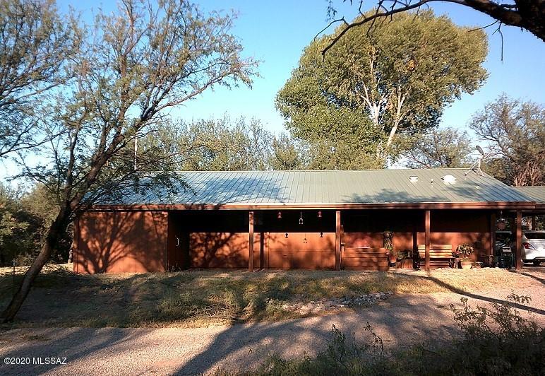 Sweet Home Arizona!  5 Acres! Adorable home nestled  among large mesquite trees surrounding the tranquil pond fed by an artesian well out back! Some of the many improvements include pretty vinyl plank flooring &fresh paint inside and out. Nice functional kitchen has extra large pantry with barn door closure. Cozy family/dining off the kitchen. Comfortable Living room with vaulted ceilings .Big covered porch & full length arizona room not included in s/f. Metal roof, heat pump new in 2014. Horse facilities include 4 stall metal barn, with  storage and covered parking area for your tractor,plus hay barn. Extra large pump house for more storage. Fenced in garden area with water, peach and plum tree included. See attached personal property and furnishings to be included