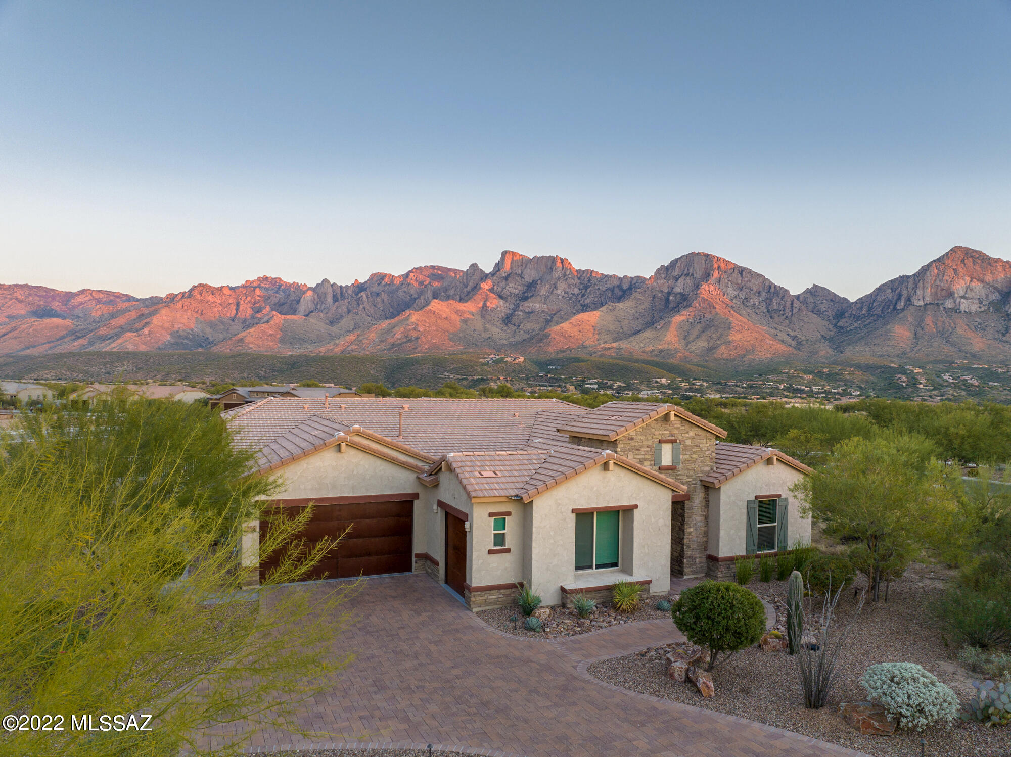 Exquisite Model Home Strategically Designed to take Full Advantage of the Unobstructed Panoramic Catalina/Pusch Ridge Views. This 3,249 sq ft 4BR/3BA w/ Flexroom on almost an acre in a Gated Community in Oro Valley has it all! Open Concept Design w/ Coffered & Tray High Ceiling. This Luxurious Dream Kitchen includes Quartz CounterTops & Quatrz Slab Backslash, Oversized Waterfall Island, Gas Range, Eat In Kitchen & Walk In Pantry. Spacious Primary Suite w/ Spa Like Bathroom has Double Vanity, Soak Tub, Luxury Shower & Huge Walk In Closet. 2nd BR has On Suite & 3rd BR has Jack & Jill Bath off of Flexroom. Custom Pebble Tec, Heated Salt Water Pool & Spa, w/ In-Floor Cleaning System & Wi-Fi enabled controls.  Extensive Covered Patio, Gas Fire Pit & Built In BBQ.