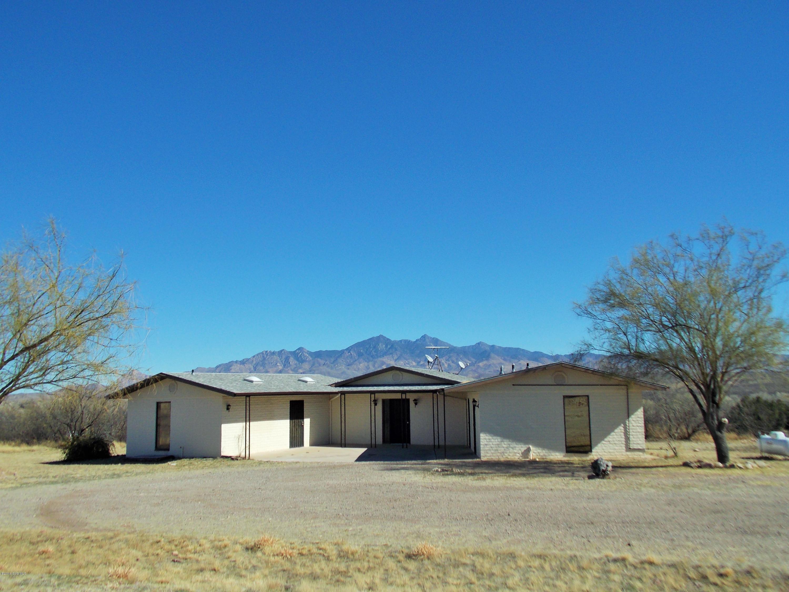 Situated on a hill, the views from this Custom 2 bedroom home are panoramic. Separate garage, carport, workshop; the well house has extra storage, has the dryer and a toilet and sink. There are separate enclosed patios of the dining room and master bedroom. Horses could be allowed with variance