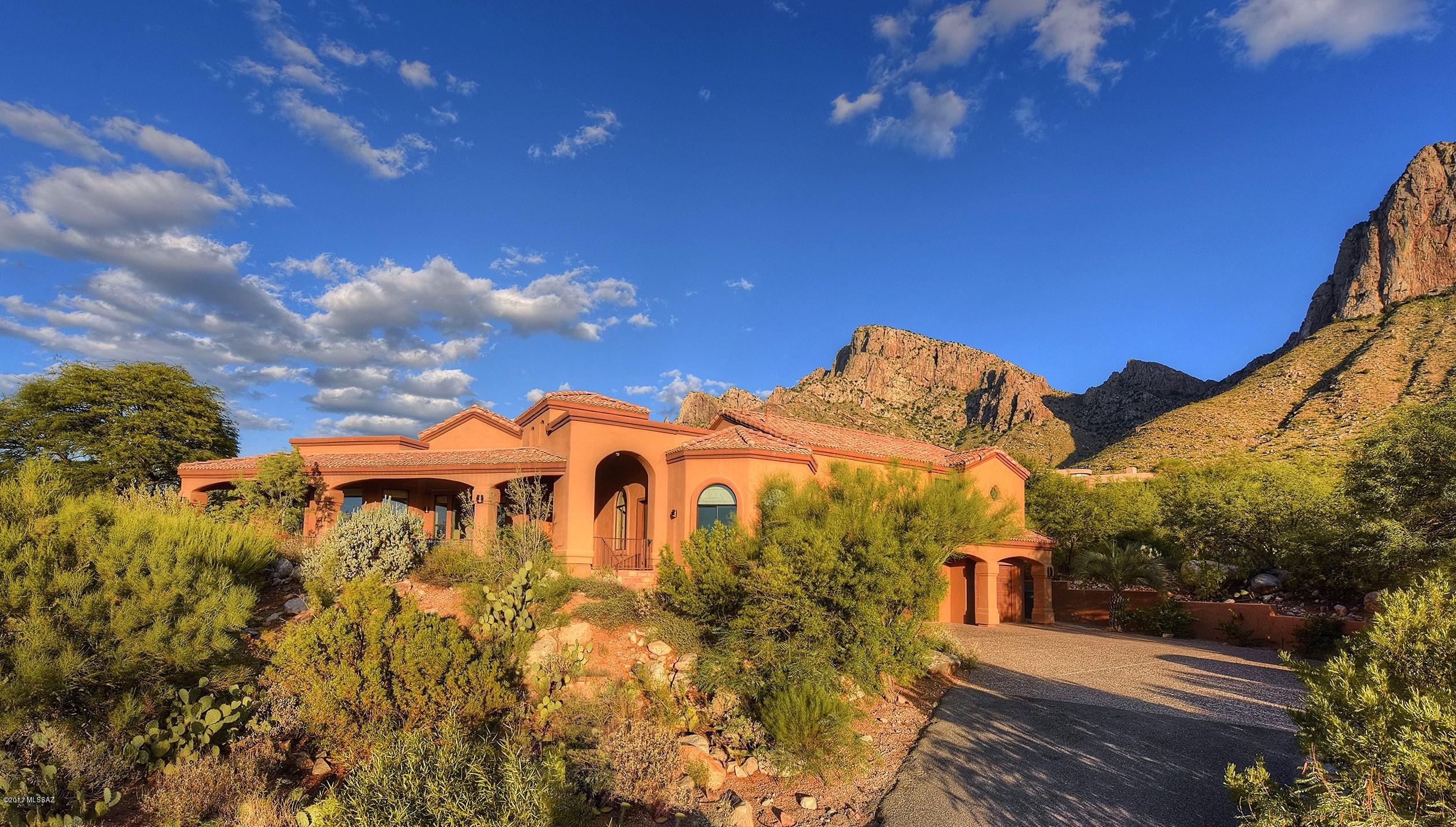 Seller shall entertain and/or counter offers from $800,000 - $820,000. Custom Mediterranean nestled in the shadows of Pusch Ridge & highlighting awe-inspiring City & Mountain Views. Listen to the melodic flutes play from the golf course while you watch the vibrant colors dance around the Old Pueblo from your private, gated Veranda. Entertain guests in the private backyard oasis featuring a covered ramada complete w/a fully equipped outdoor kitchen, citrus trees, & native foliage abound. Rejuvenate your spirit in the  warm, inviting spa as sounds of cascading water fall into the sparkling pool below. The heart of the home boasts rustic stained cabinetry, gas range, double oven, water purifier &  RO system. Open concept great room features a wet bar, cozy gas fireplace, & breathtaking views! Retire to the upstairs master retreat where you will be greeted w/double French doors that open onto a private balcony & a spacious master bath featuring walk-in closets, custom tile shower, separate vanities, & a soaking tub sure to melt your day away. Schedule your showing today!