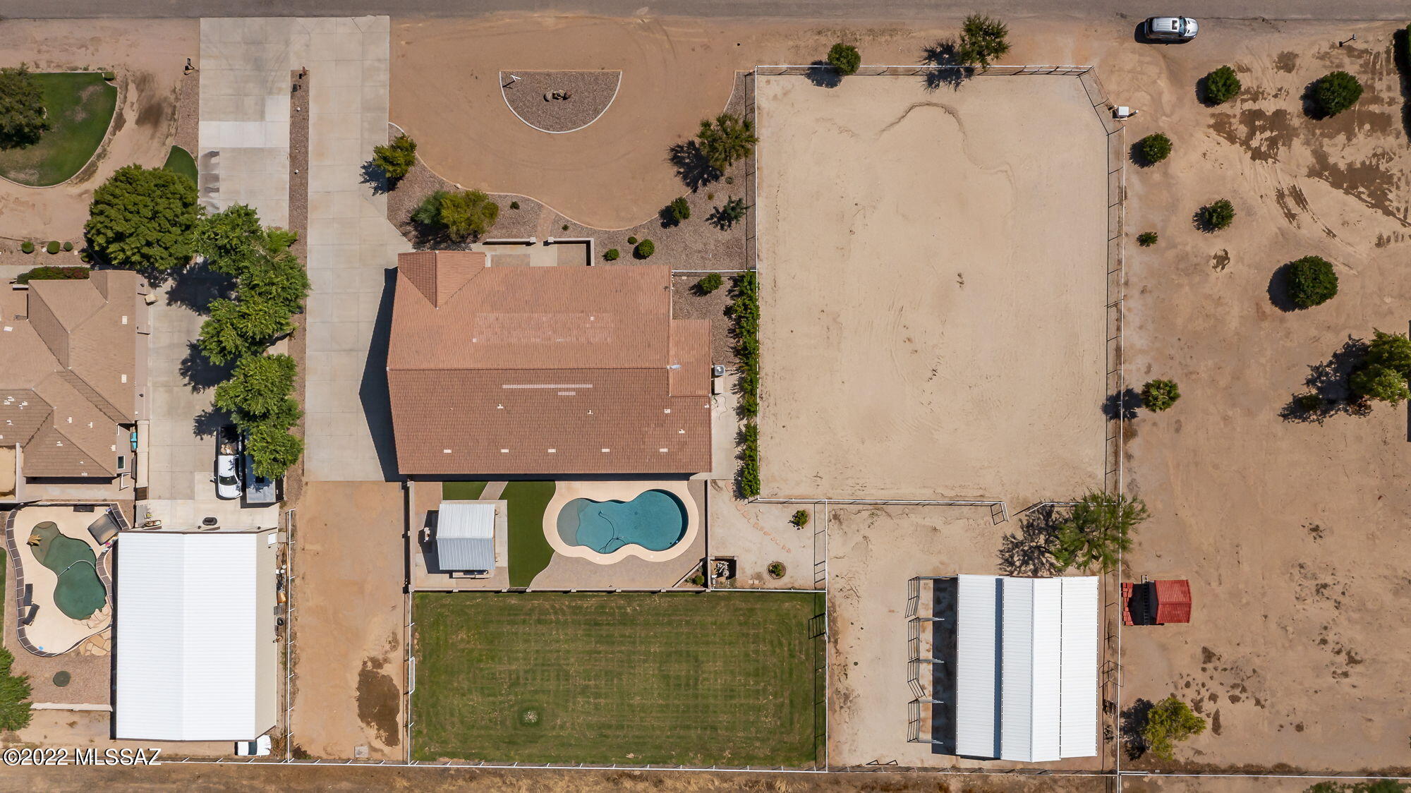 Pristine property with irrigated pasture, arena, custom Blue Ribbon Barn, pool, outdoor kitchen w/ fireplace, mountain views, & an extended 4 car garage! The show barn has it all w/ a tack room, feed storage, washing bay, fly spray system, auto waters, feeders & is equipped w/ switches /outlets throughout. The home features 10' ceilings, high quality engineered hardwood flooring, formal dining & living areas, den, game room, craft room, NEW AC UNITS & many more new features listed in the docs. The kitchen offers ample cabinetry, pantry, granite countertops, SS appliances, & an island. The master suite features travertine tile, sep tub/shower, spacious walk-in his/her closets & double sinks. Tons of storage options t/o! This home was built to entertain both indoors & outdoors, must see!