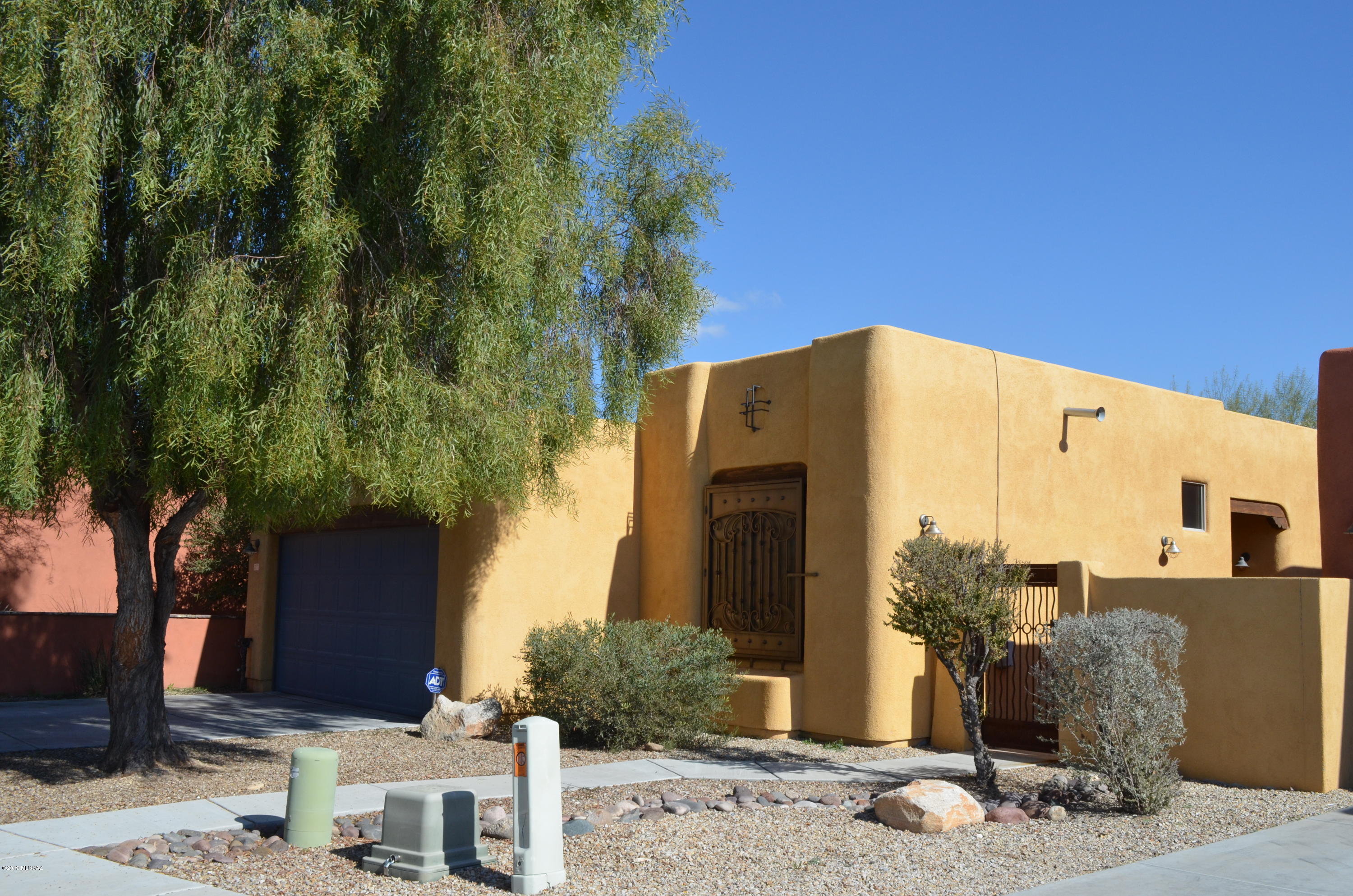REDUCED Price! Charming 2 BD/2 BA w/Den or Dining Room by TJ Bednar with open floor plan and many upgrades throughout, including granite counters, stainless steel appliances, designer lighting fixtures, concrete floors, decorative custom wrought iron on doors and windows in an all electric energy efficient home.  Split floor plan with a huge great room, high ceilings, vega beam columns and a beehive fireplace.  Large Kitchen with eat in area, breakfast bar, pantry and lots of cabinets.  Lovely Master Bedroom with spacious walk-in closet and Master Bath with executive height dual sink vanity, large shower and more storage.  Gated courtyard entrance with beautifully landscaped front and backyards with no neighbors behind.  Move in Ready!  Lakeside Park is down the street with boating, fishing, playgrounds and sports fields.  A must see!  Agent is related to Seller.