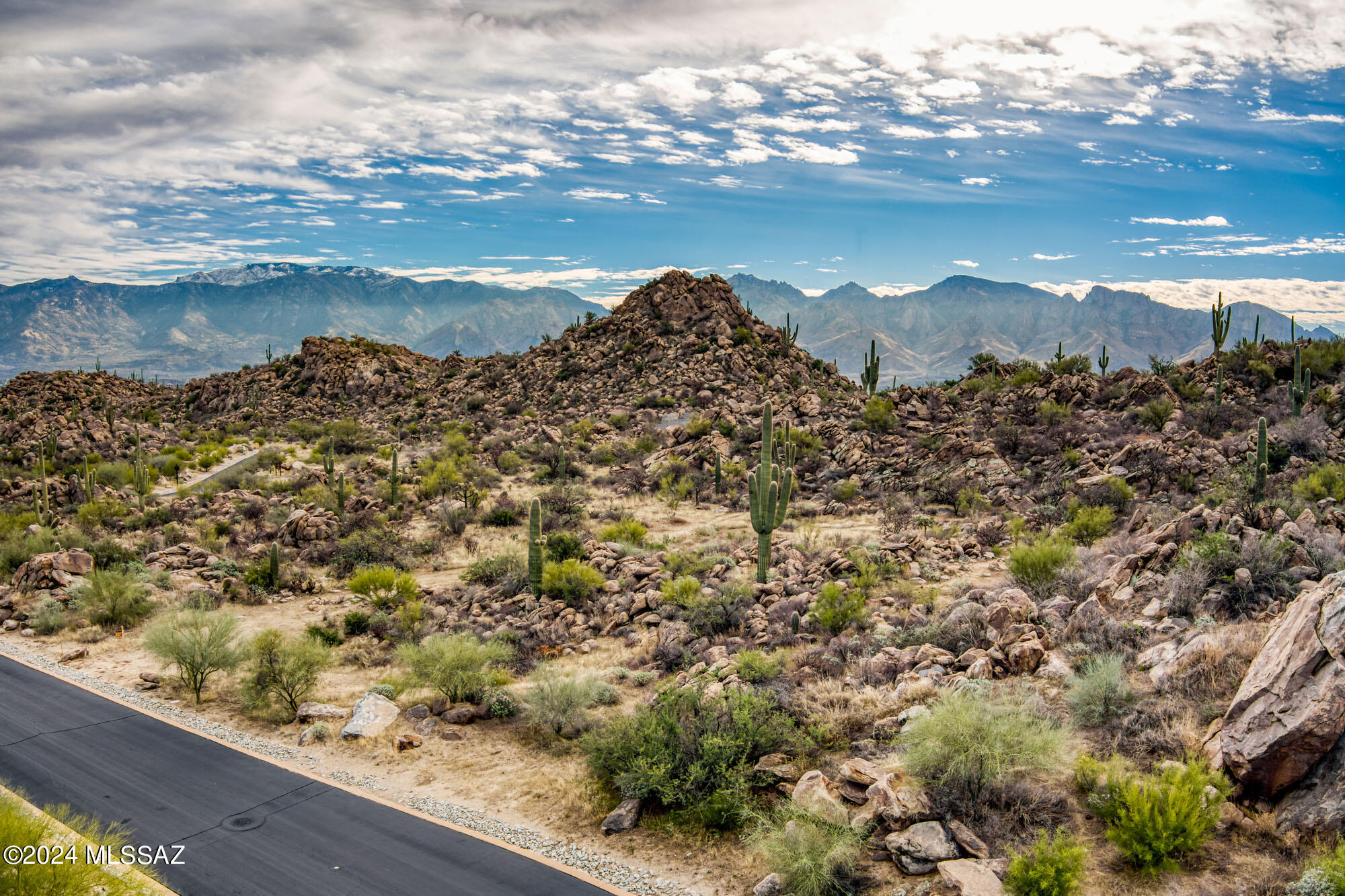 Discover your dream homesite in the prestigious, gated Stone Canyon community. This 1.25-acre property offers unparalleled privacy, serenity, and breathtaking views of the Catalina Mountains, with stunning rock formations and lush desert vegetation. The flat building envelope ensures lower site preparation costs, making it the ideal foundation for your custom luxury home. The adjacent lots 324 & 325 have been combined, adding to the peaceful ambiance of this prime location. Stone Canyon is renowned for its world-class amenities, including a championship golf course, an upscale restaurant and bar, and a state-of-the-art health and fitness club with two pools, a hot tub, tennis, and pickleball courts. Enjoy the perfect balance of seclusion and convenience, with quick access to Oro Valley's